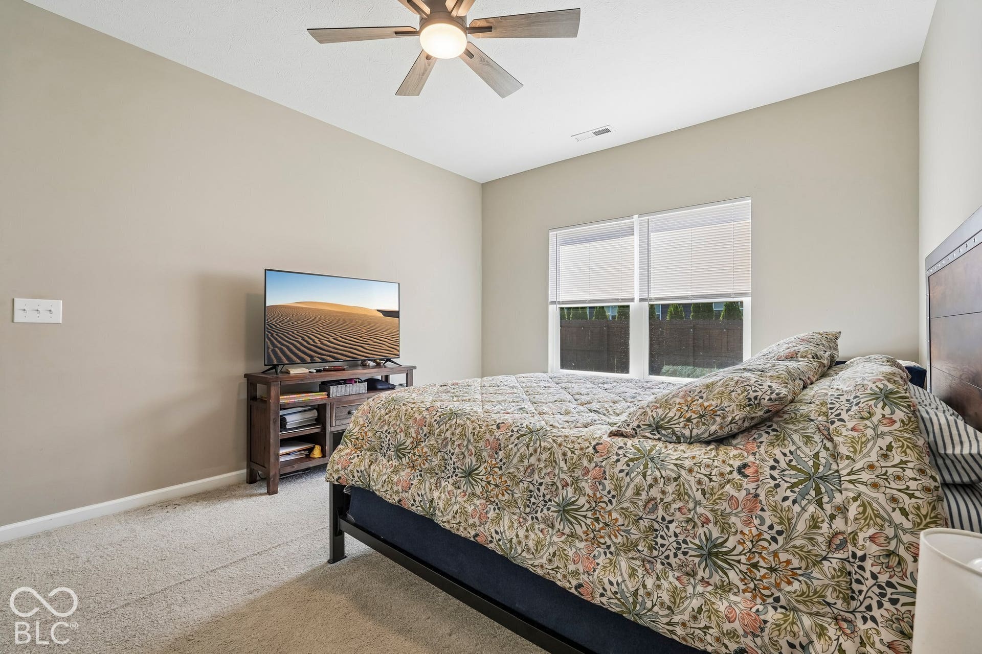 2945 W Calimanco Lane, Monrovia, IN 46157 Vaulted ceiling, ceiling fan with integrated lighting, carpeted flooring, and a window with blinds