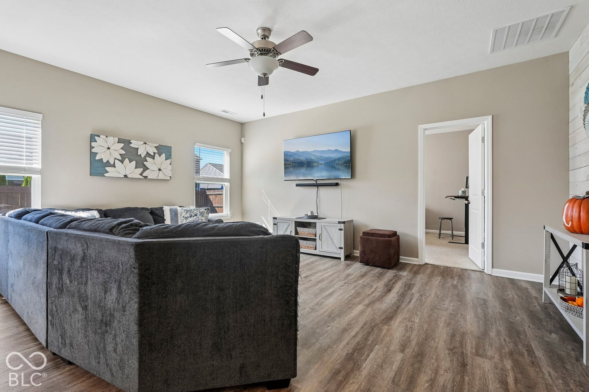 2945 W Calimanco Lane, Monrovia, IN 46157 Wood-finish flooring throughout, multiple windows with blinds, and a ceiling fan with integrated lighting