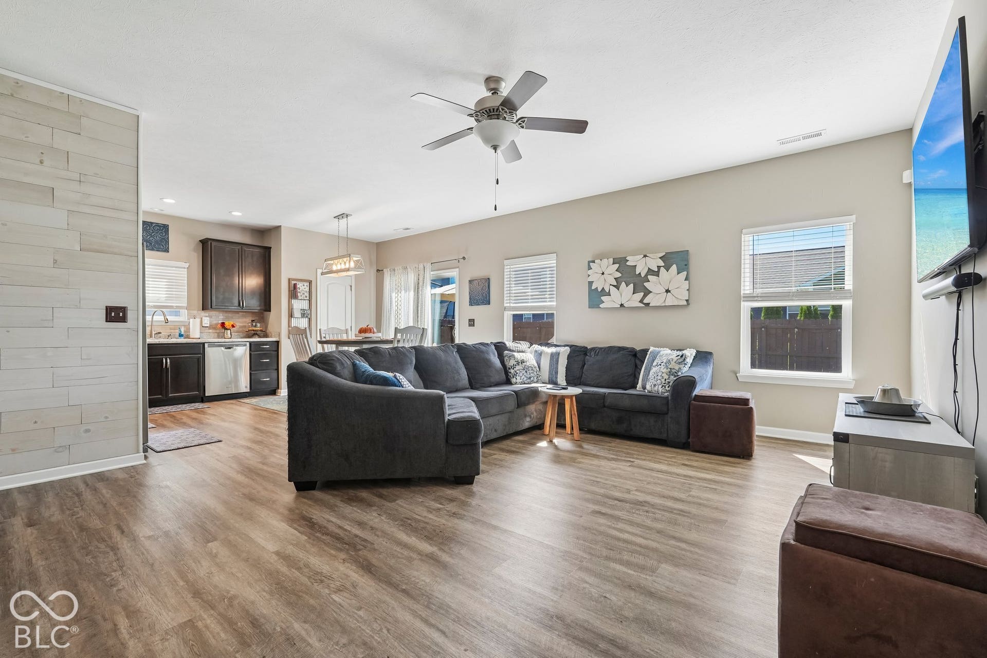 2945 W Calimanco Lane, Monrovia, IN 46157 Open concept living space featuring wood-finish flooring, a ceiling fan with integrated lighting, and multiple windows