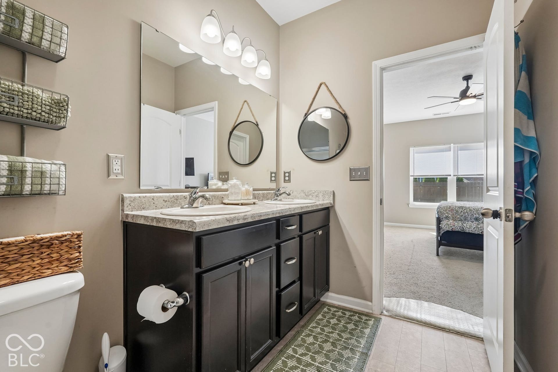 2945 W Calimanco Lane, Monrovia, IN 46157 Dual sink vanity with dark wood-finish cabinetry and a light-toned countertop