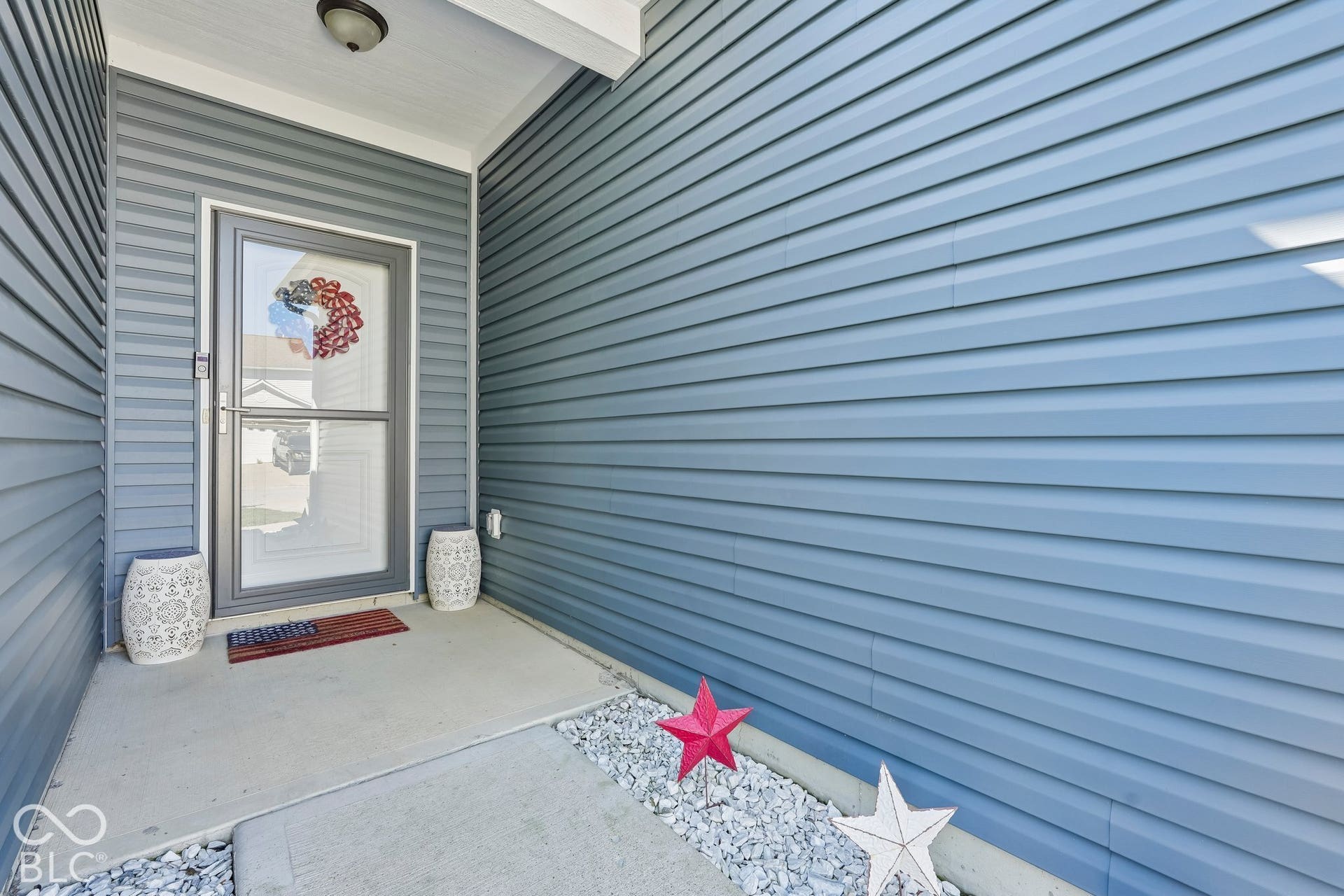 2945 W Calimanco Lane, Monrovia, IN 46157 Entryway with siding exterior, concrete porch, and overhead lighting