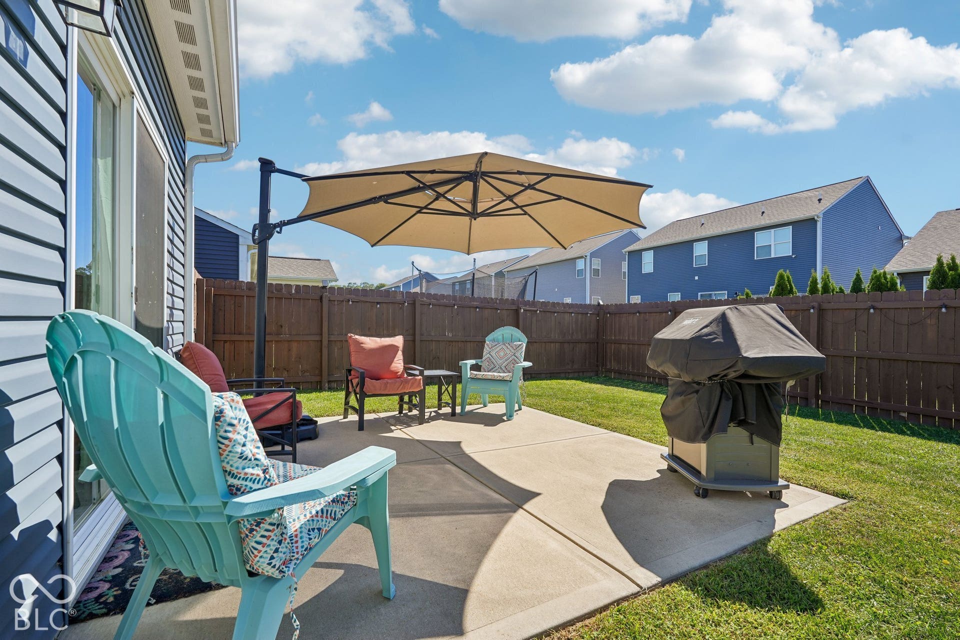 2945 W Calimanco Lane, Monrovia, IN 46157 Expansive concrete patio with direct access to interior, surrounded by a wood privacy fence, and featuring a manicured lawn