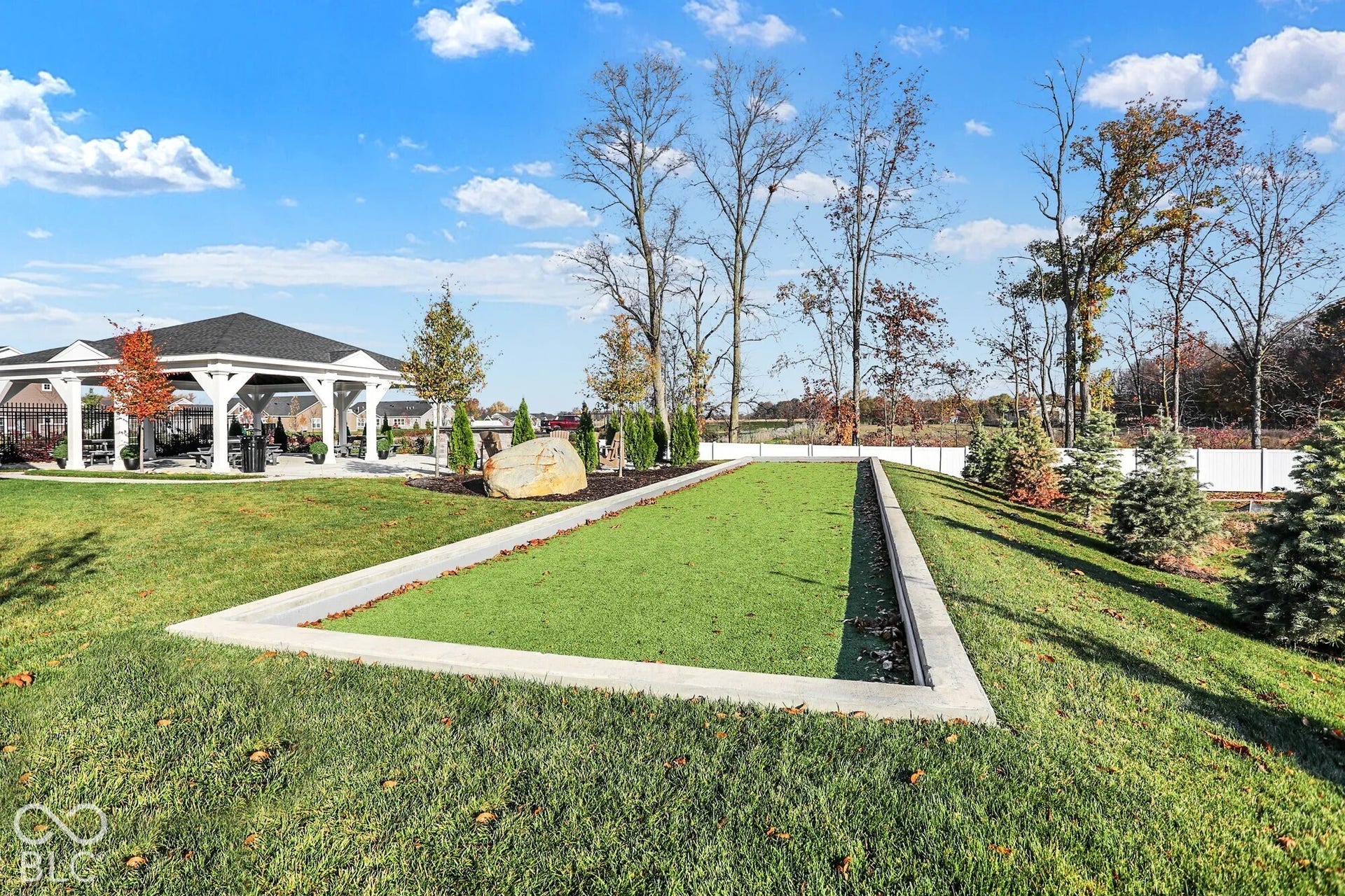 Bocce ball court with artificial turf, surrounded by a concrete border