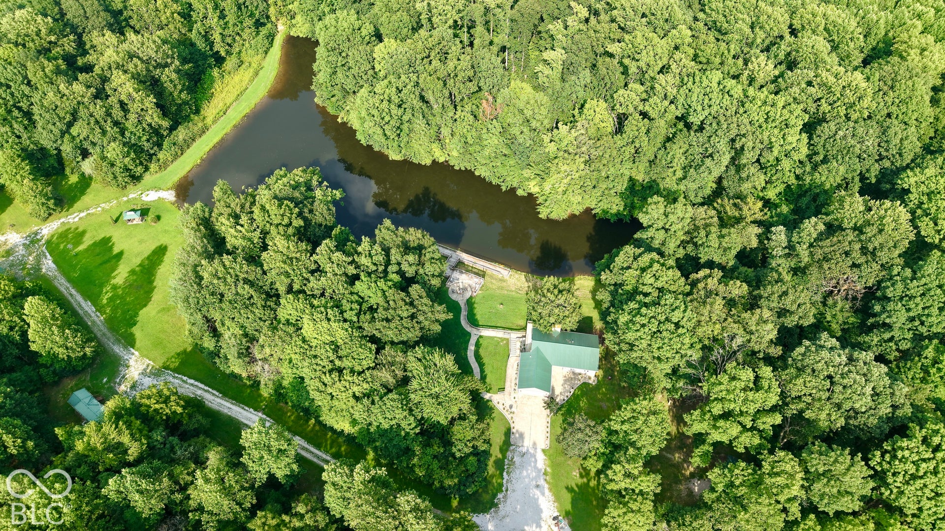 Expansive property with a private pond surrounded by abundant mature trees