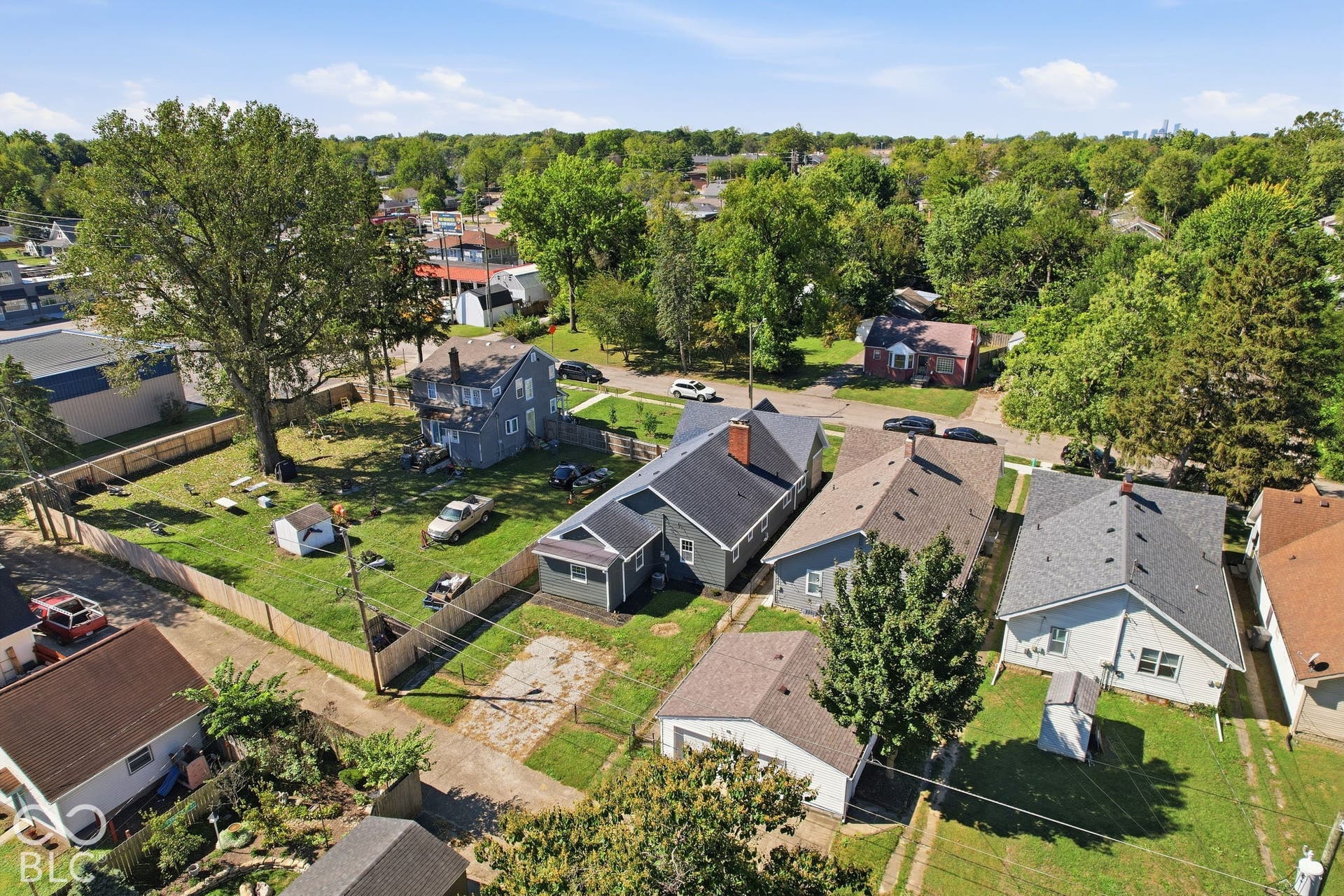 Fenced property with expansive green space and mature trees