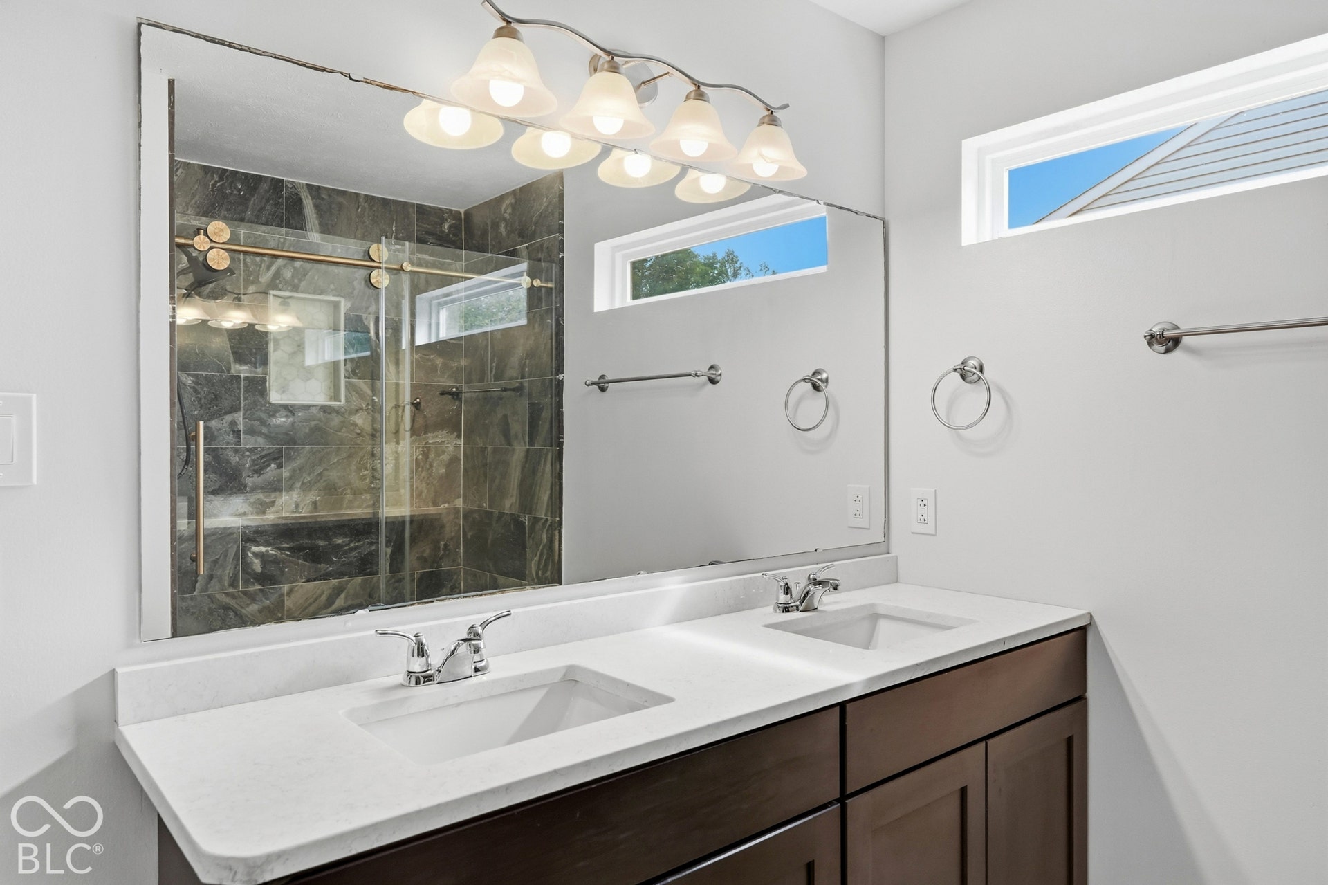 Dual vanity with white countertops and integrated sinks