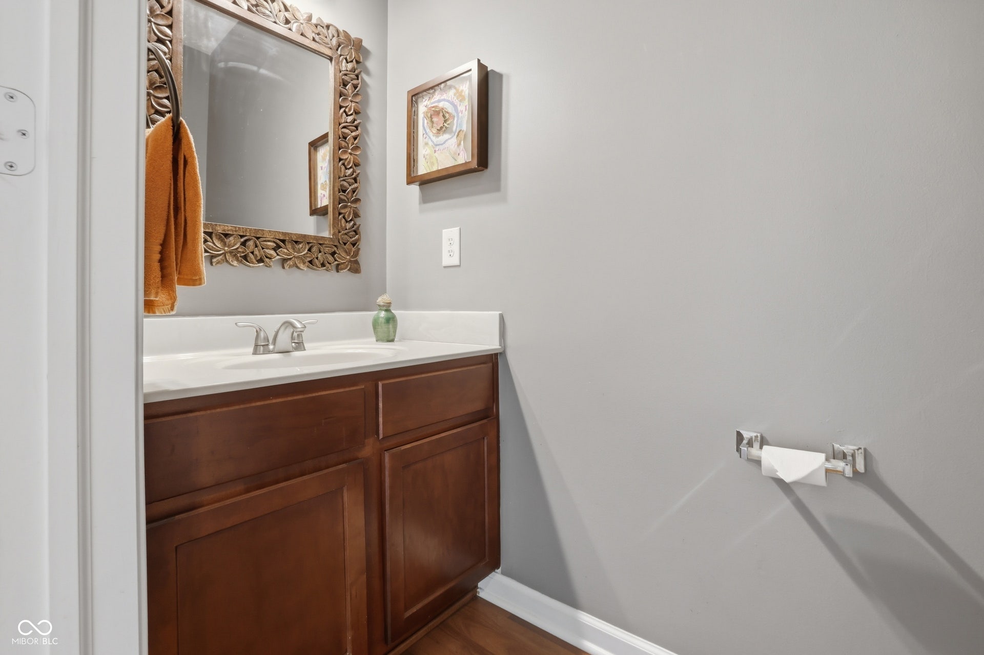 Half bathroom on the main. Vanity with a white countertop and undermount sink
