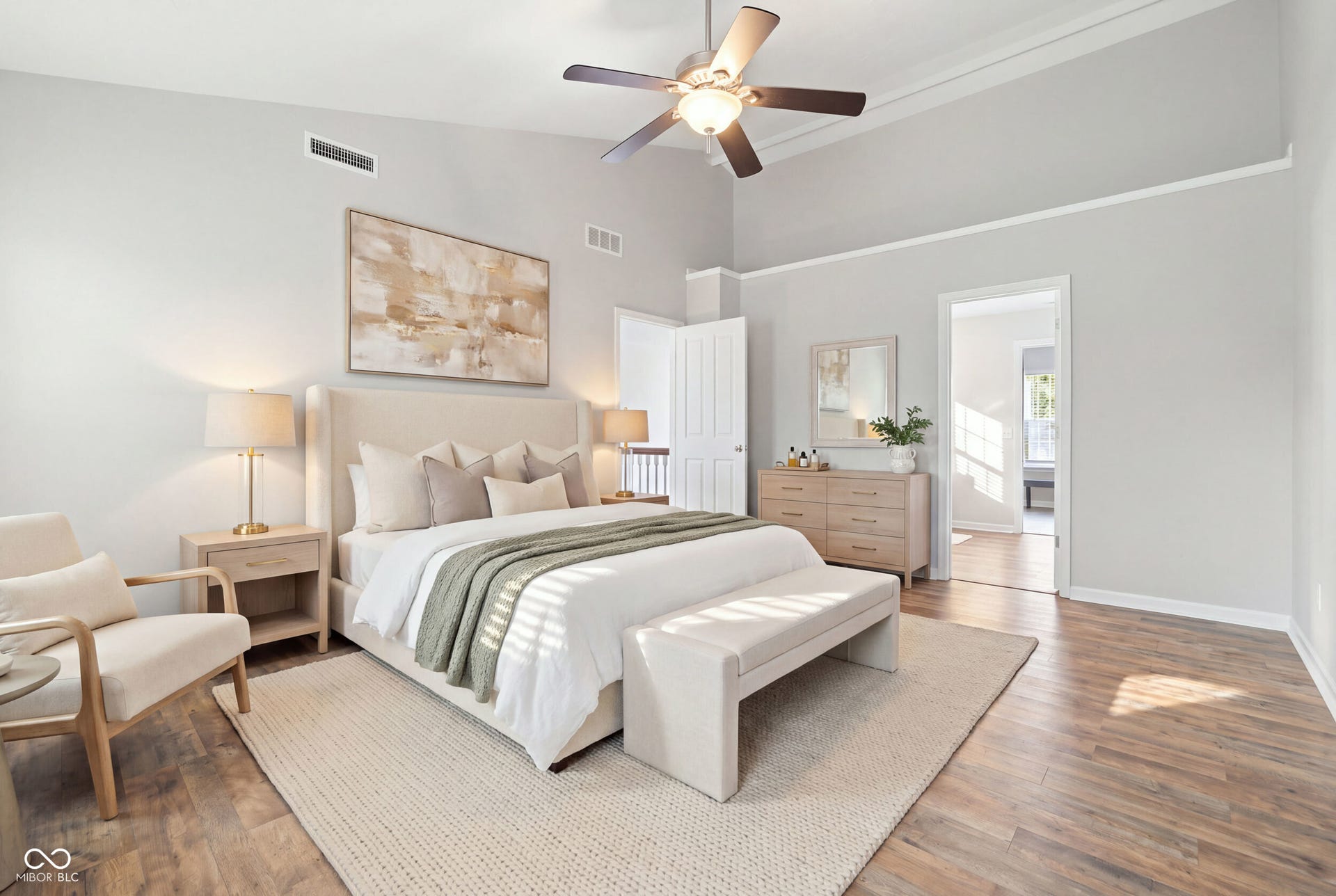 Vaulted ceilings with crown molding, ceiling fan, wood-finish flooring, and recessed doorway