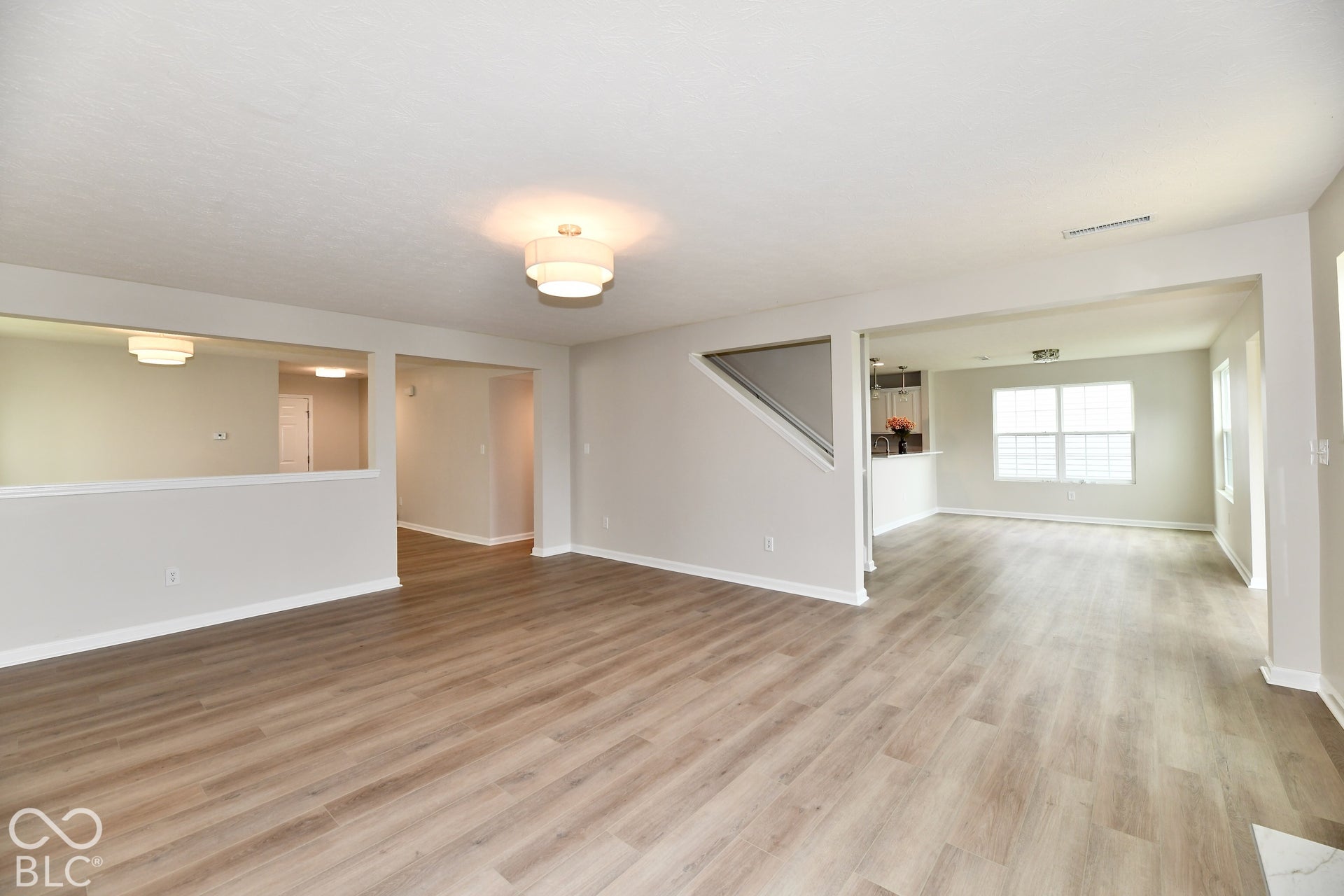 Expansive interior with wood-finish flooring, light-toned walls, and recessed lighting