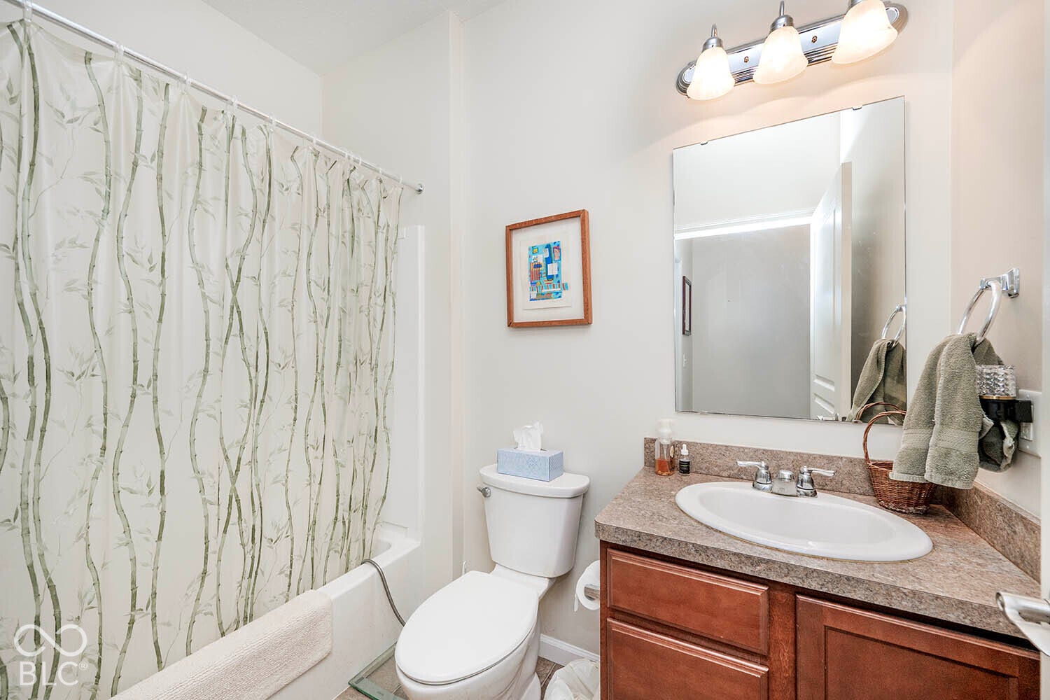 The 2nd full bathroom features a tub/shower, vanity with wood-finish cabinetry, integrated sink, and laminate countertop