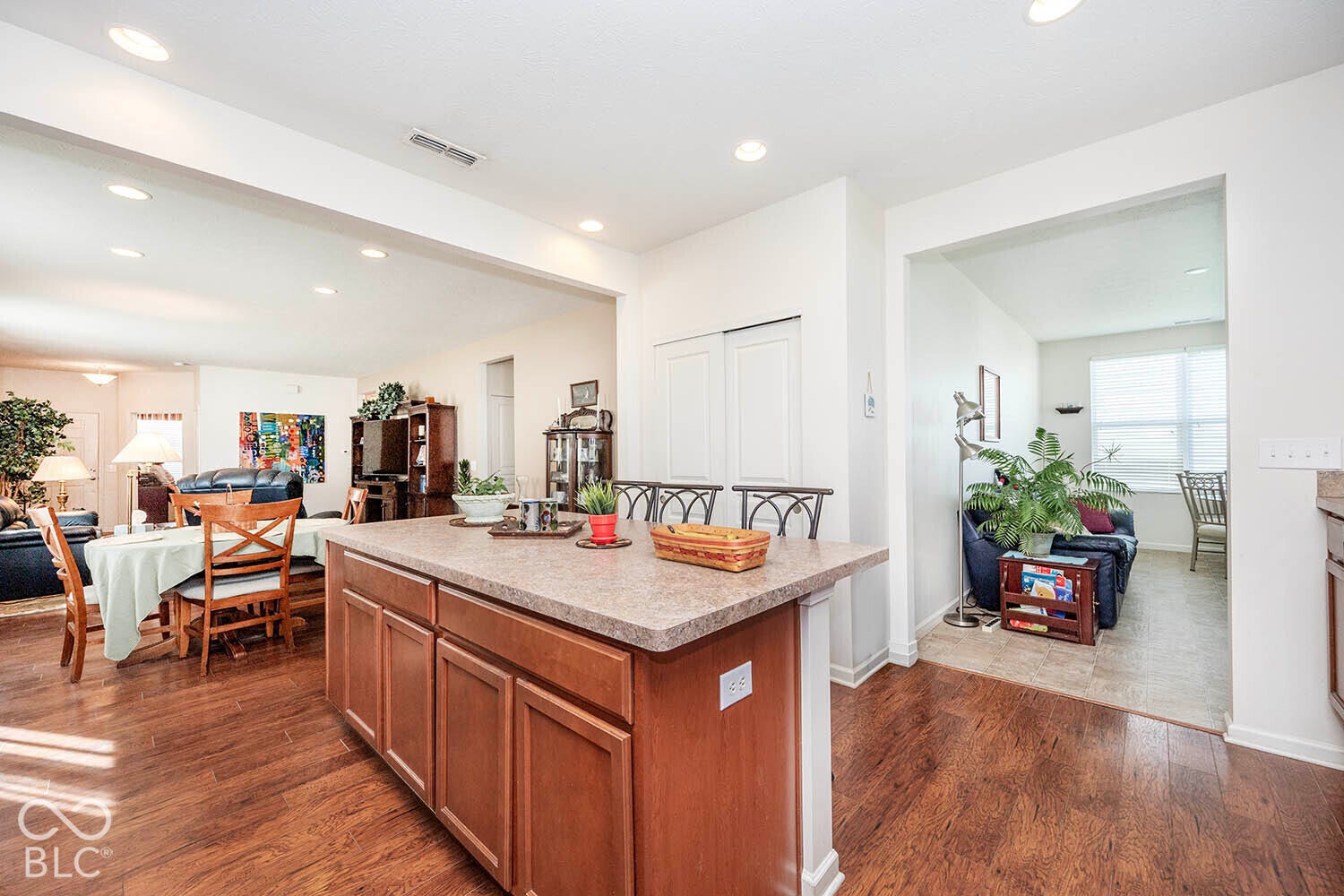 View from the corner of the kitchen to the sunroom and dining area
