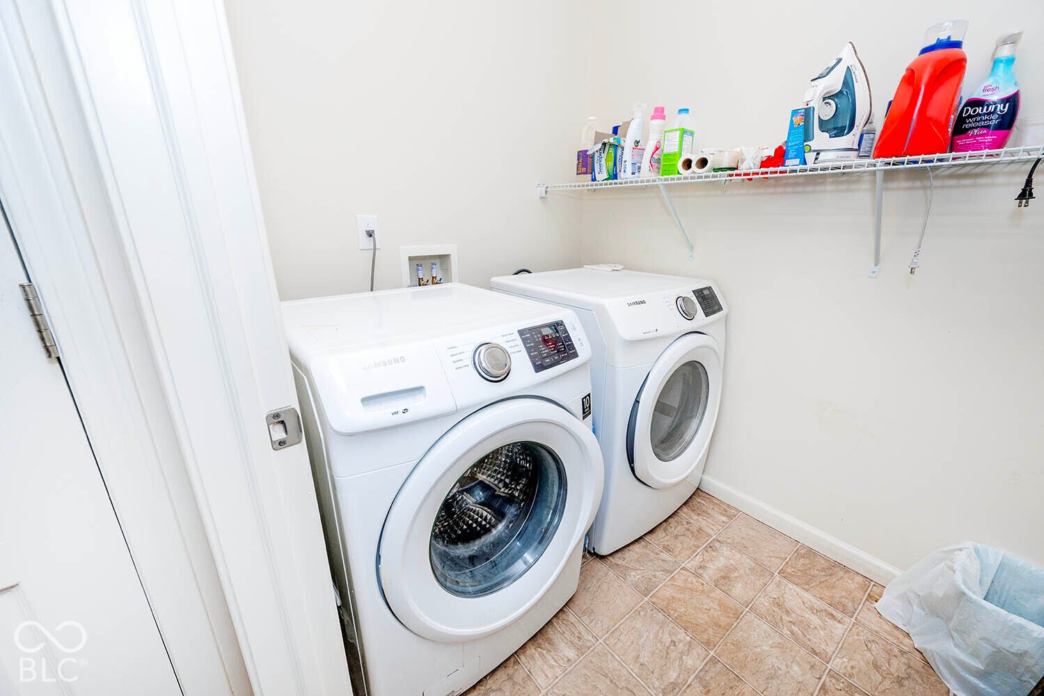 Laundry area featuring a wire storage shelf and vinyl flooring. The Washer and Dryer stay with the home!