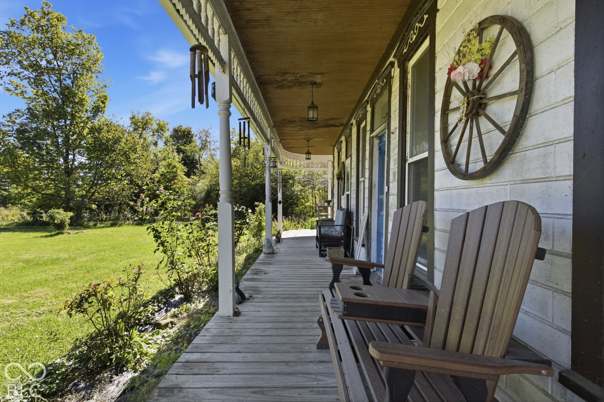 Expansive wooden porch with decorative white pillars