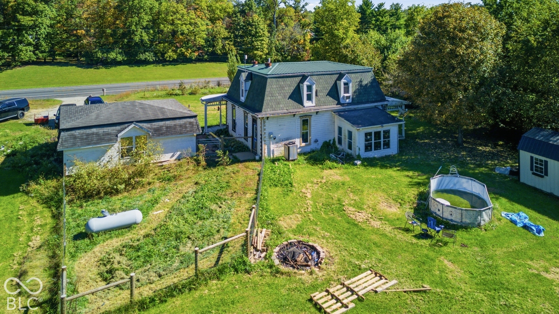 Two-story residence with a dormer roof and a detached garage