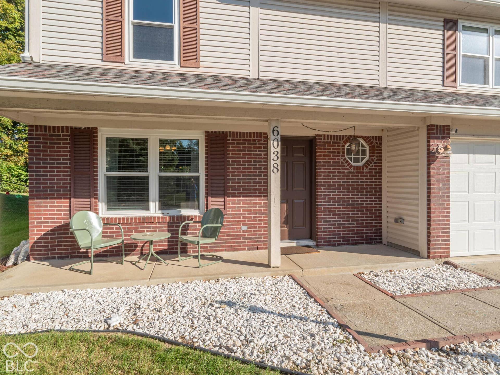 Brick and siding exterior with a covered porch
