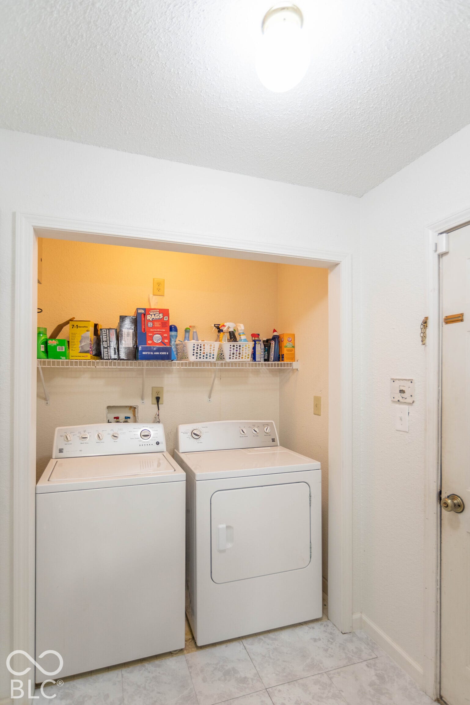 Laundry area on main with vinyl tile flooring and recessed shelving. Washer/dryer not included