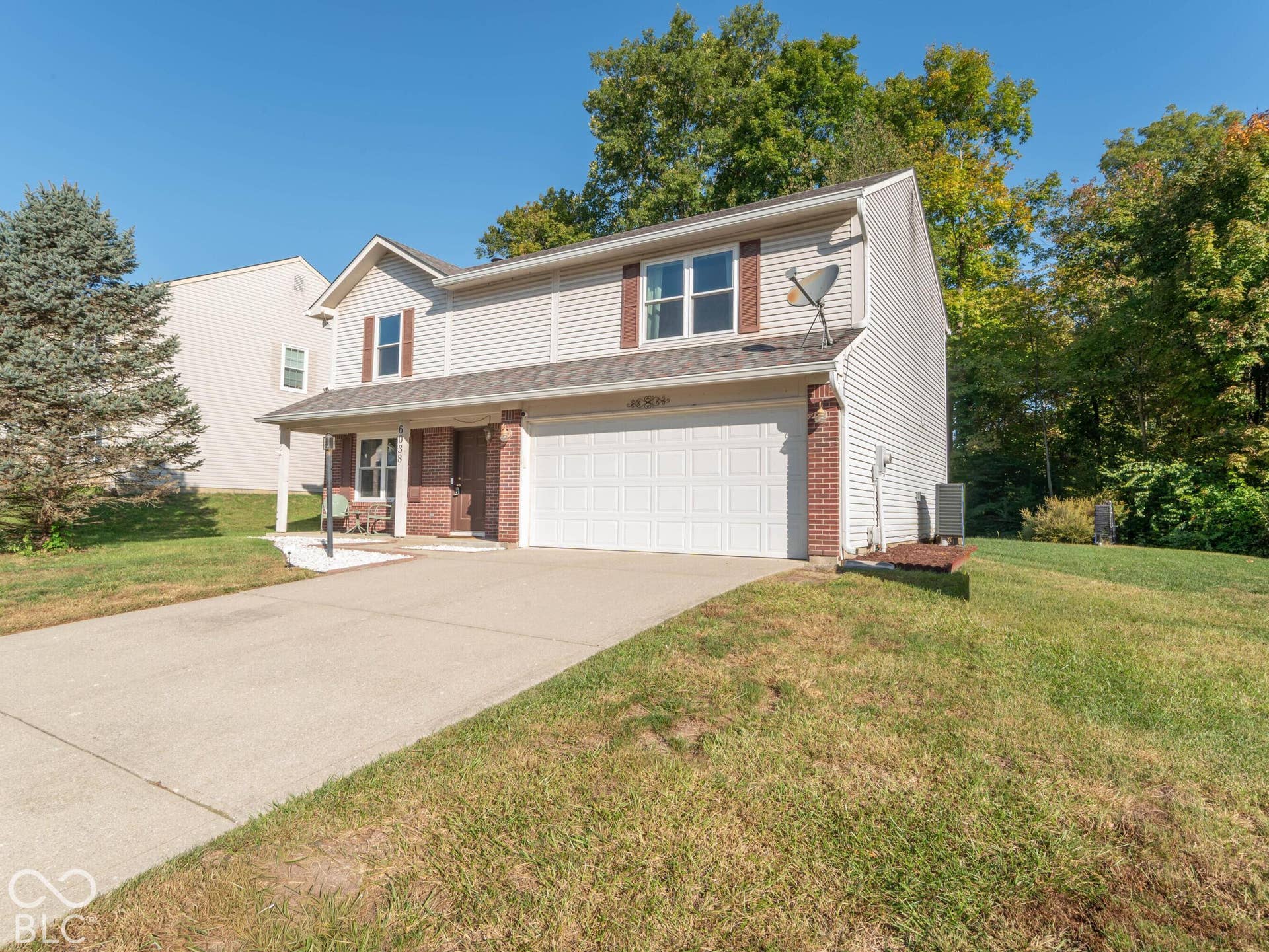 Two-story residence with a covered front porch and an attached garage