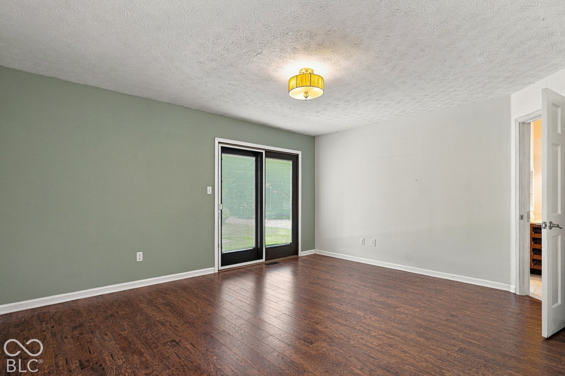 Wood-finish flooring, two-tone wall paint, and overhead lighting