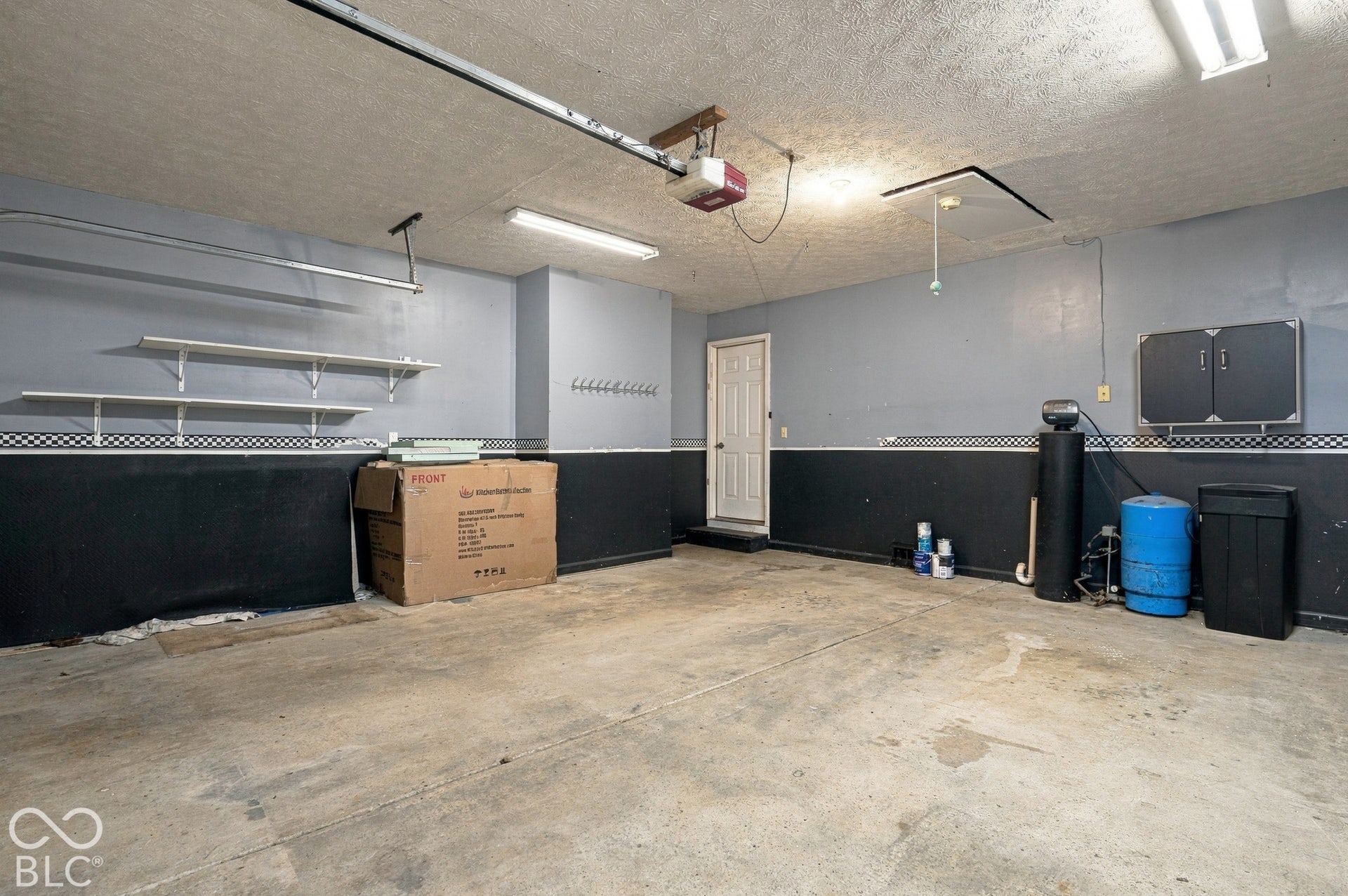 Garage with concrete flooring and overhead lighting