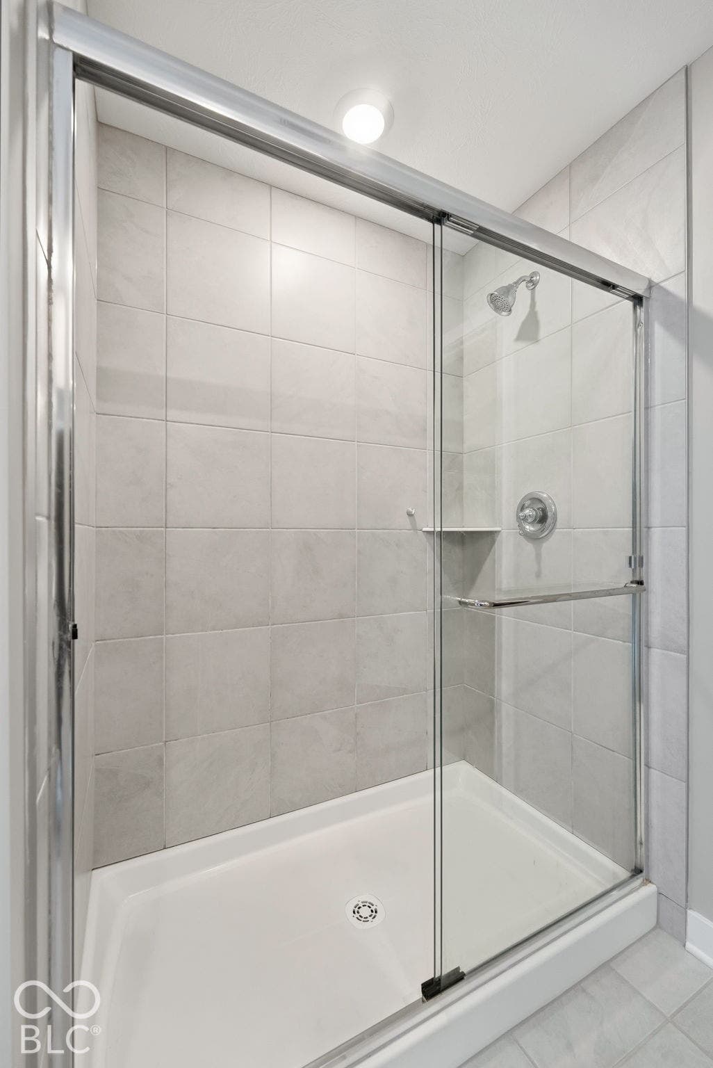 Beautiful walk-in tiled shower in primary bathroom.