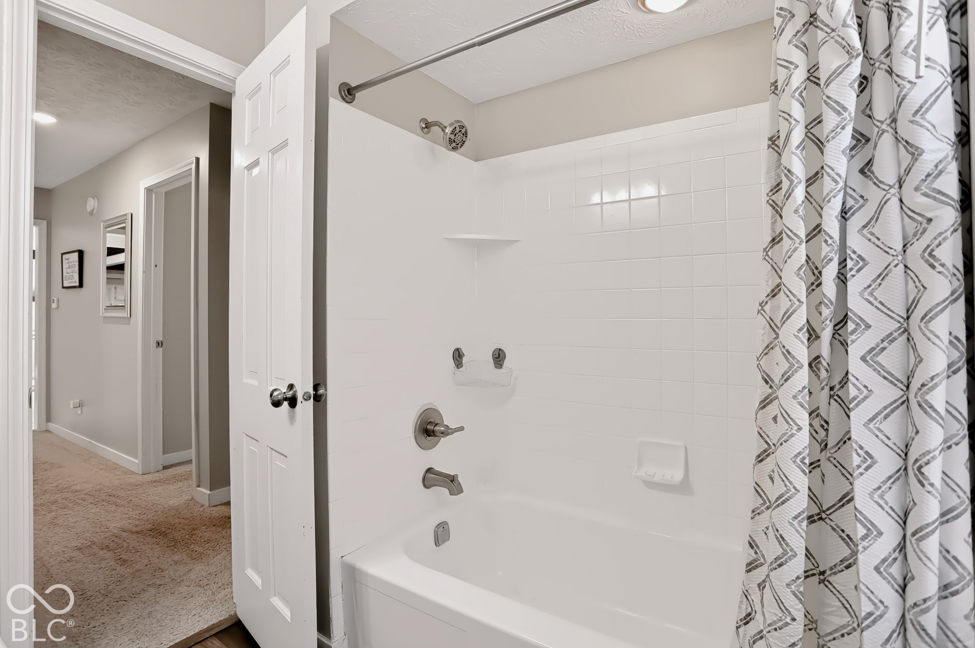 White subway tile shower surround with integrated soap dishes