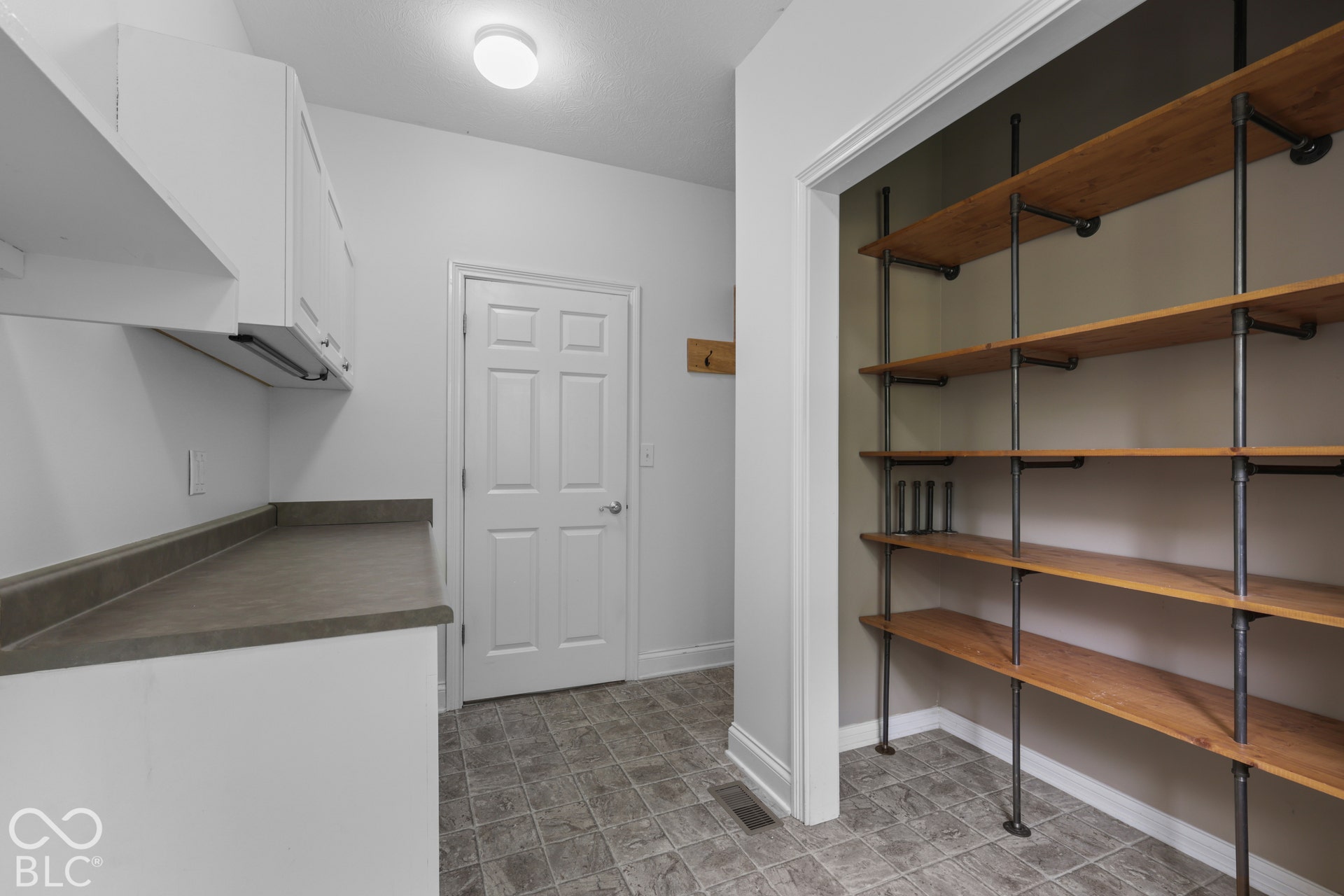 5976 E Holes Crossing Drive, Crawfordsville, IN 47933 MAIN FLOOR LAUNDRY HAS CABINETRY & TONS OF SHELVING FOR STORAGE AND FOLDING COUNTERTOP.