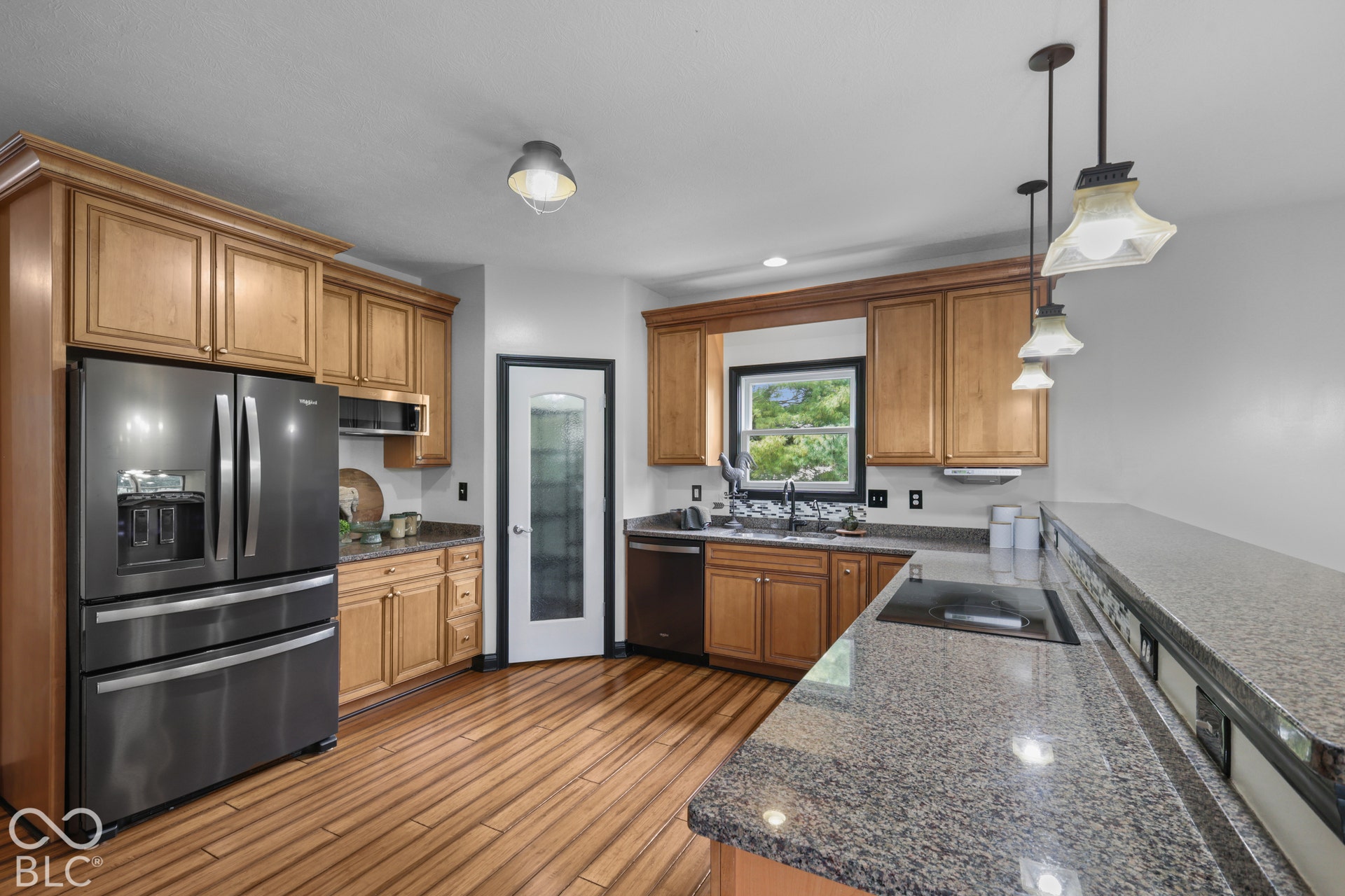 5976 E Holes Crossing Drive, Crawfordsville, IN 47933 STUNNING KITCHEN WITH CORNER PANTRY, UPDATED APPLIANCES, INDUCTION COOKTOP, GRANITE COUNTERTOPS AND BAMBOO FLOORING. RO DRINKING SYSTEM AT THE SINK.