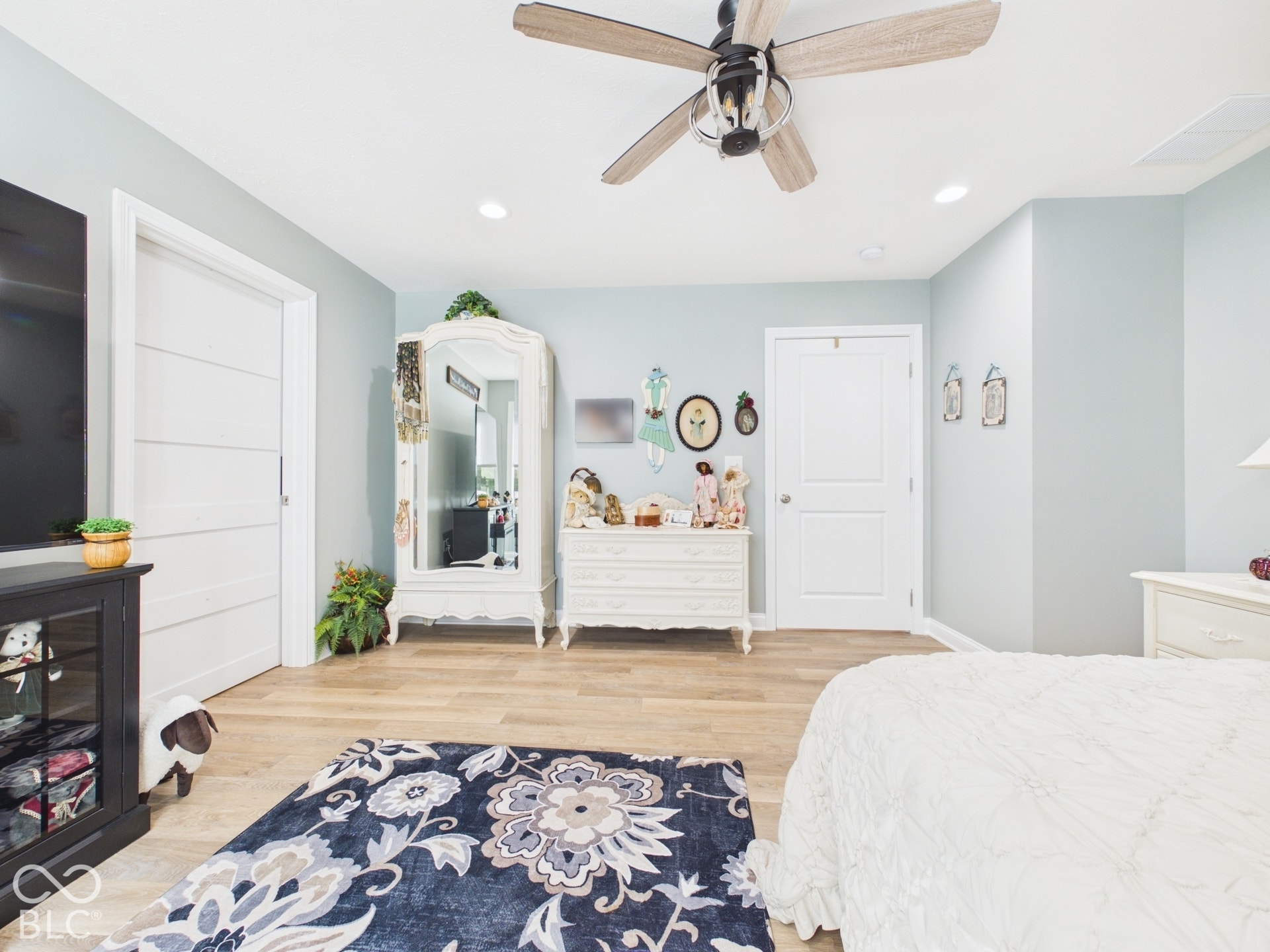 Wood-finish flooring, recessed lighting, and a ceiling fan with light fixture