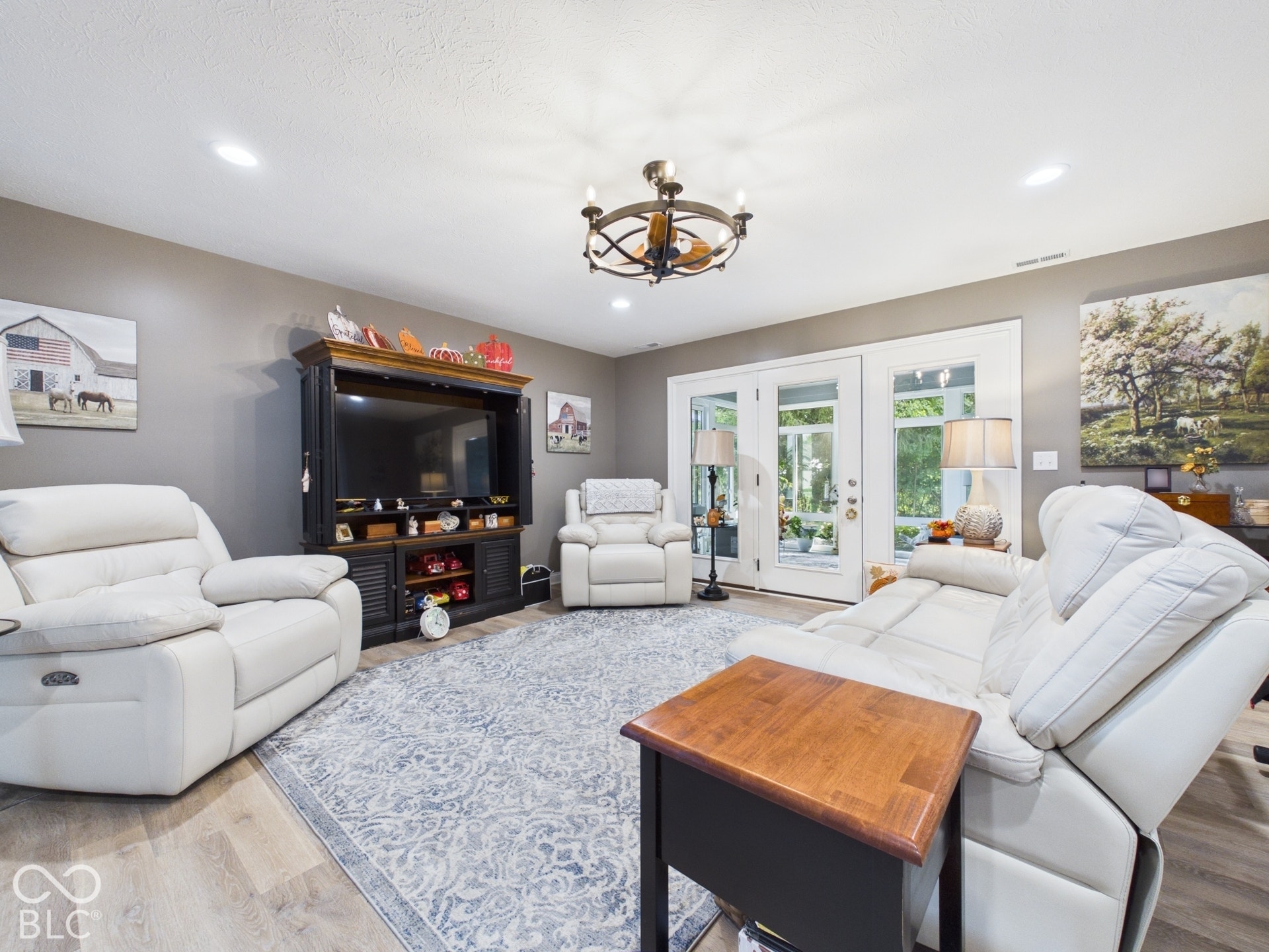 Recessed ceiling lighting, wood-finish flooring, and a decorative ceiling fan with light fixture