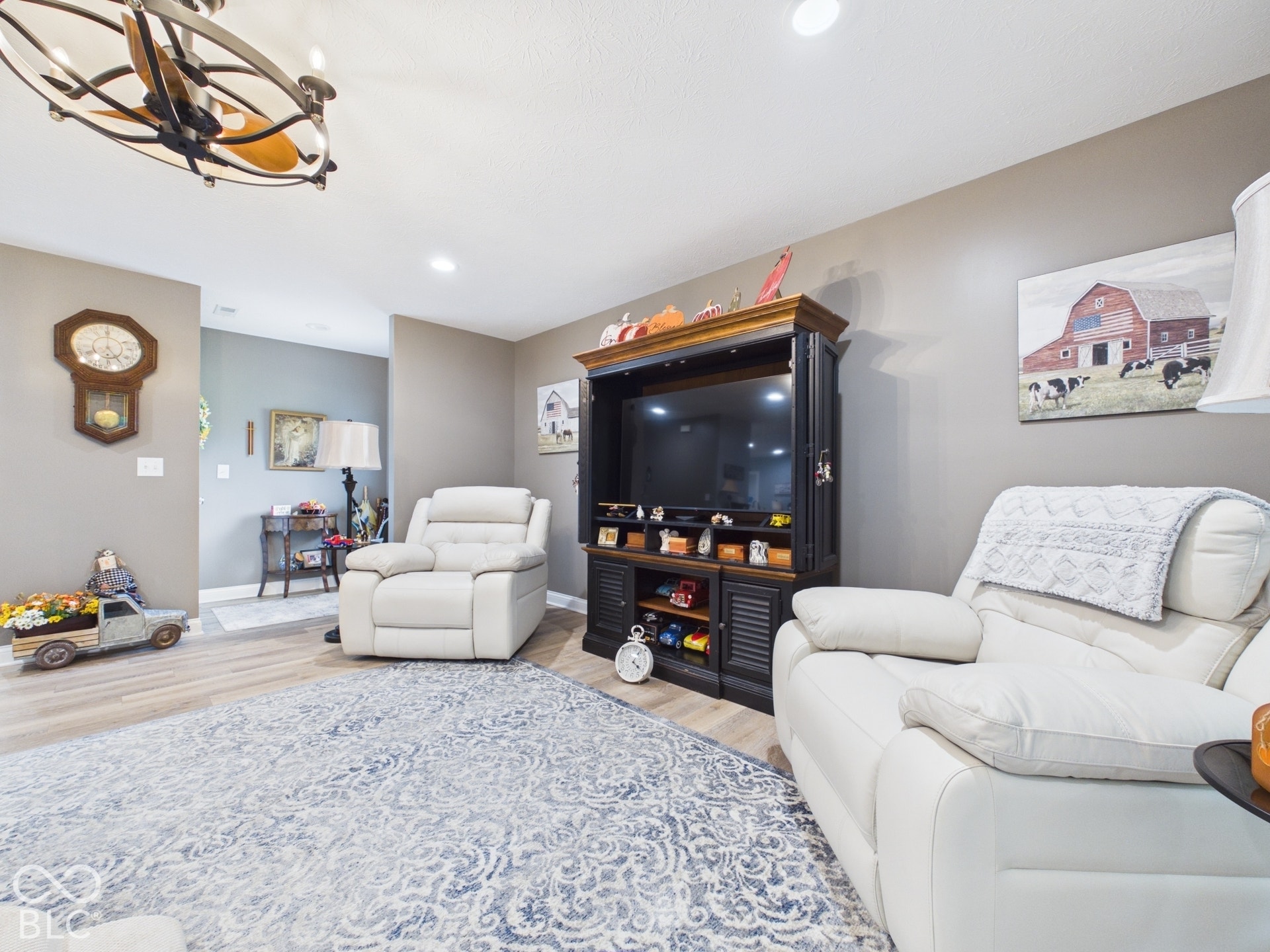Recessed lighting, wood-finish flooring, and a decorative ceiling fan