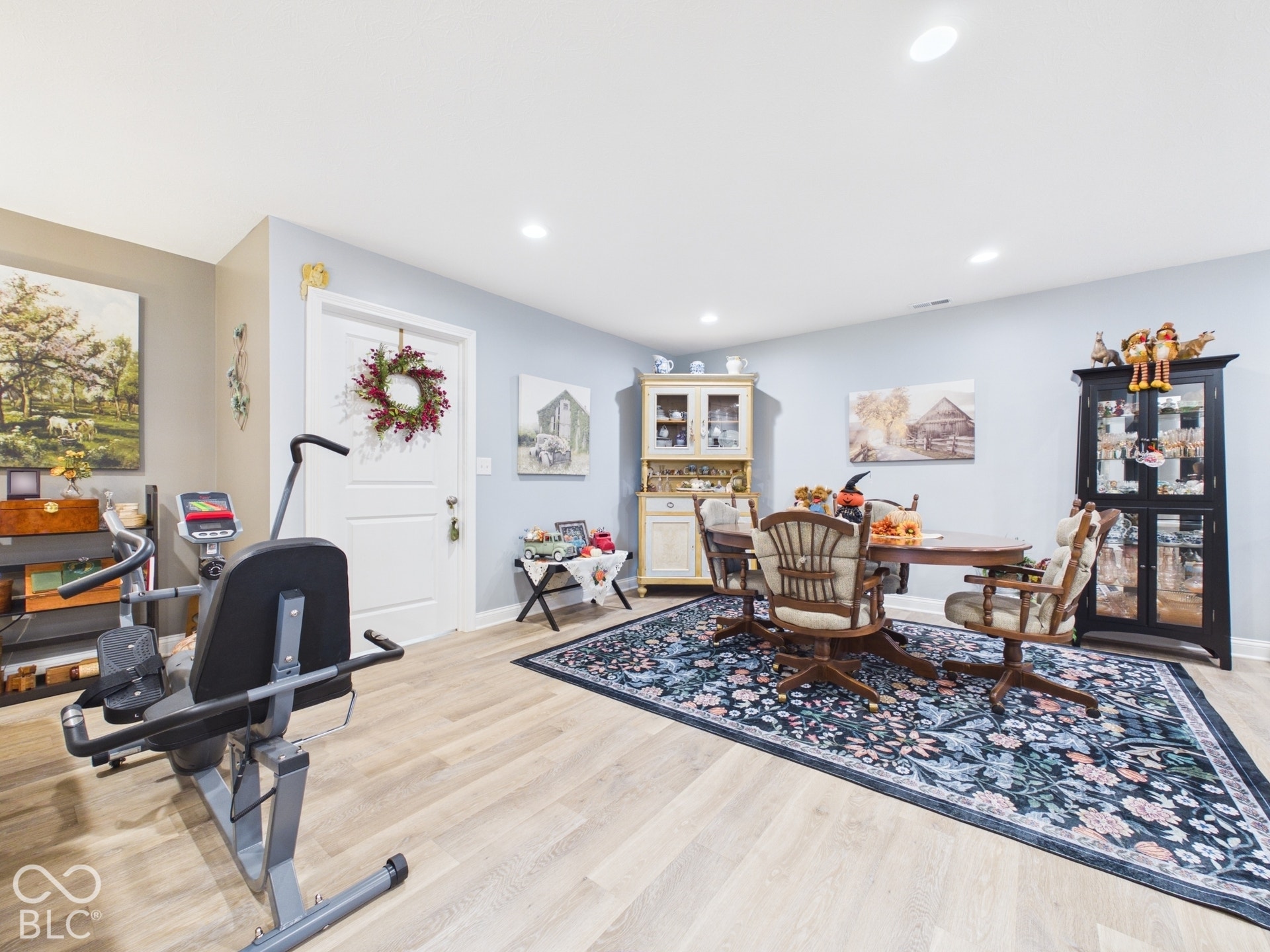 Recessed lighting illuminates the space, featuring light wood-finish flooring