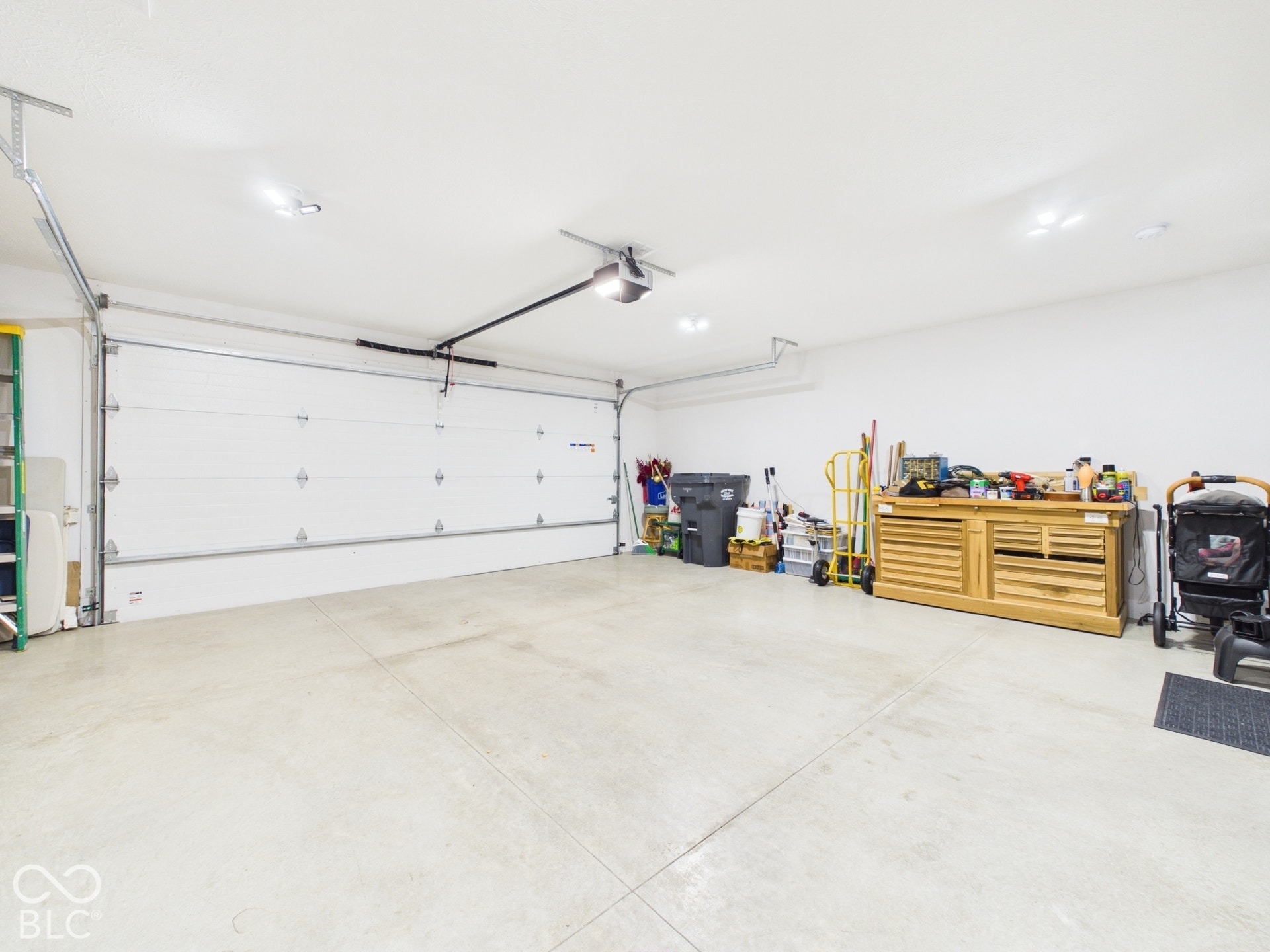 Attached garage featuring a sectional door and concrete flooring