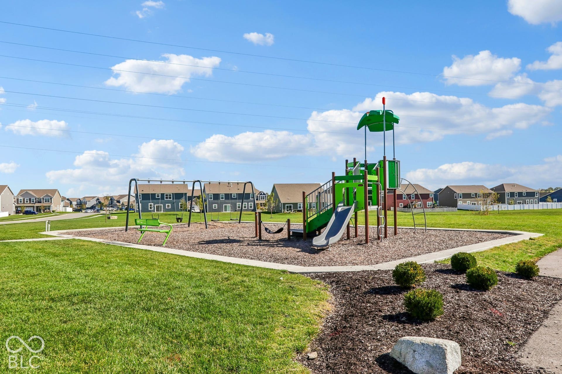 Edgewood Farms community playground featuring a swing set and slide