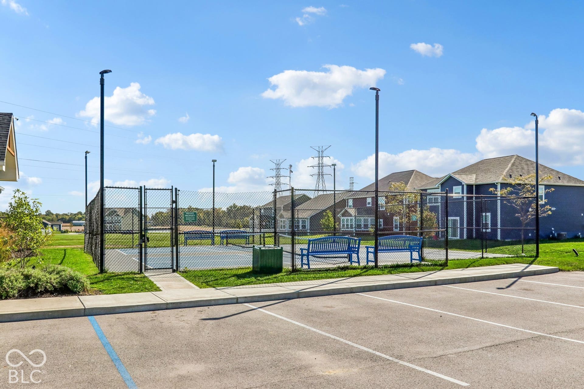 Edgewood Farms community fenced Pickleball court with benches and surrounding mature landscaping