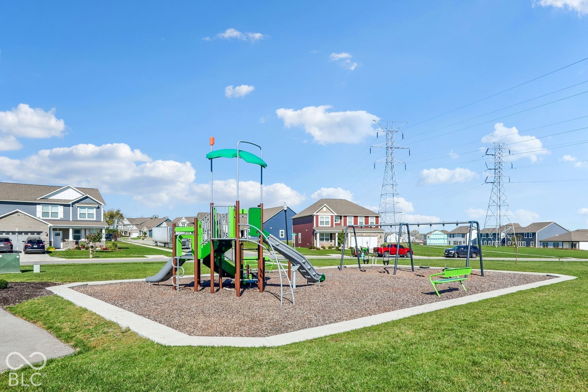 Edgewood Farms community playground featuring a swing set and slide