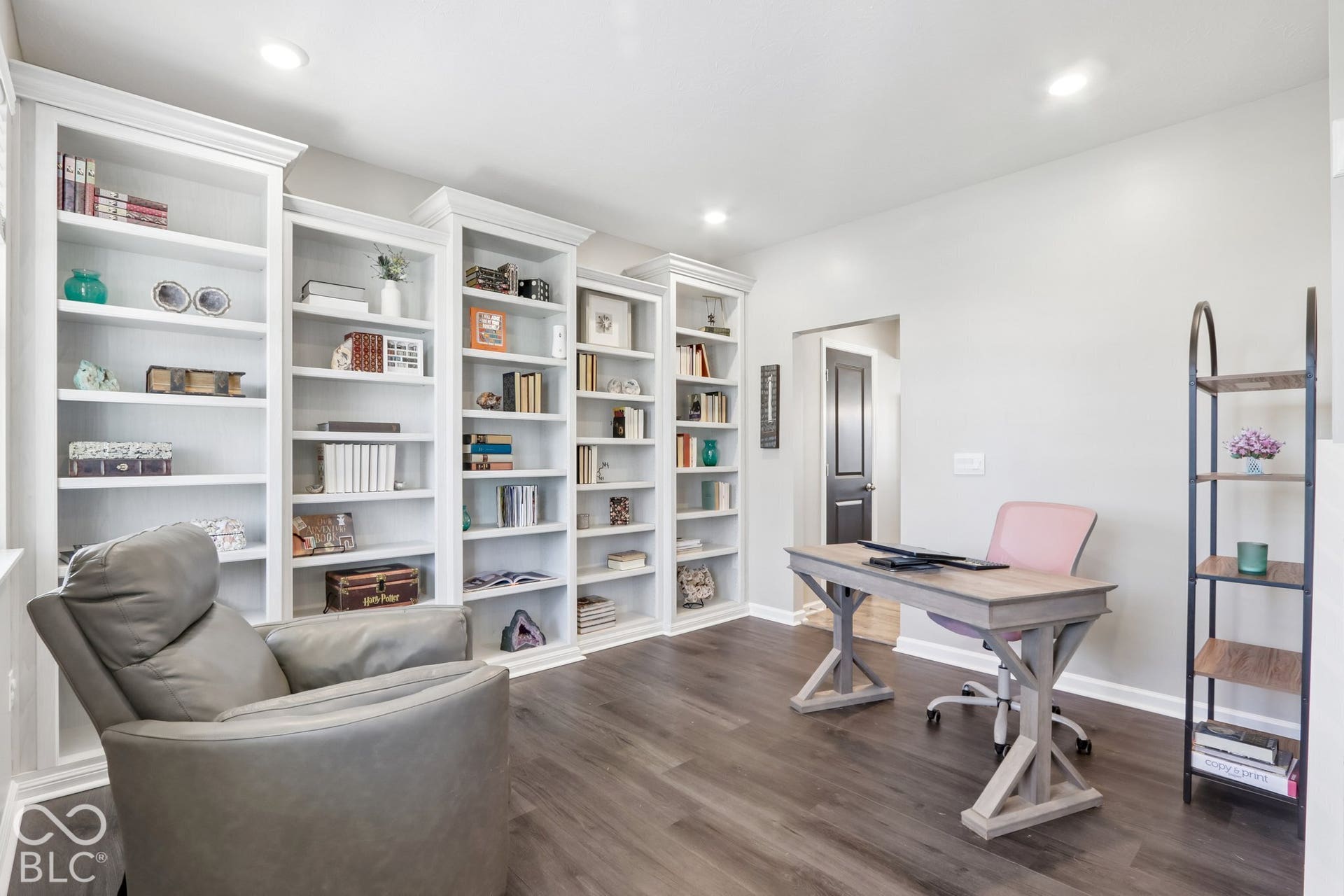 Main floor living room being used as an office, featuring built-in bookcases