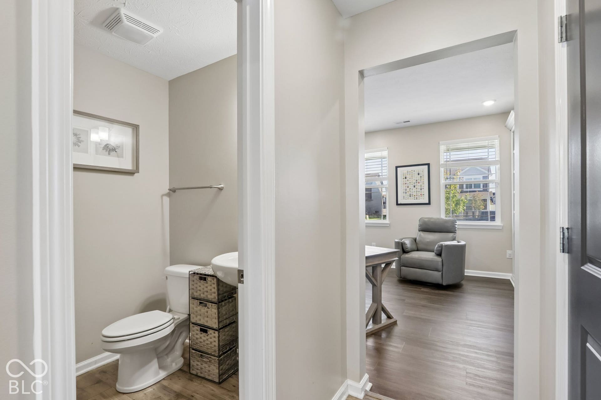 Half bathroom on main floor with a pedestal sink and toilet