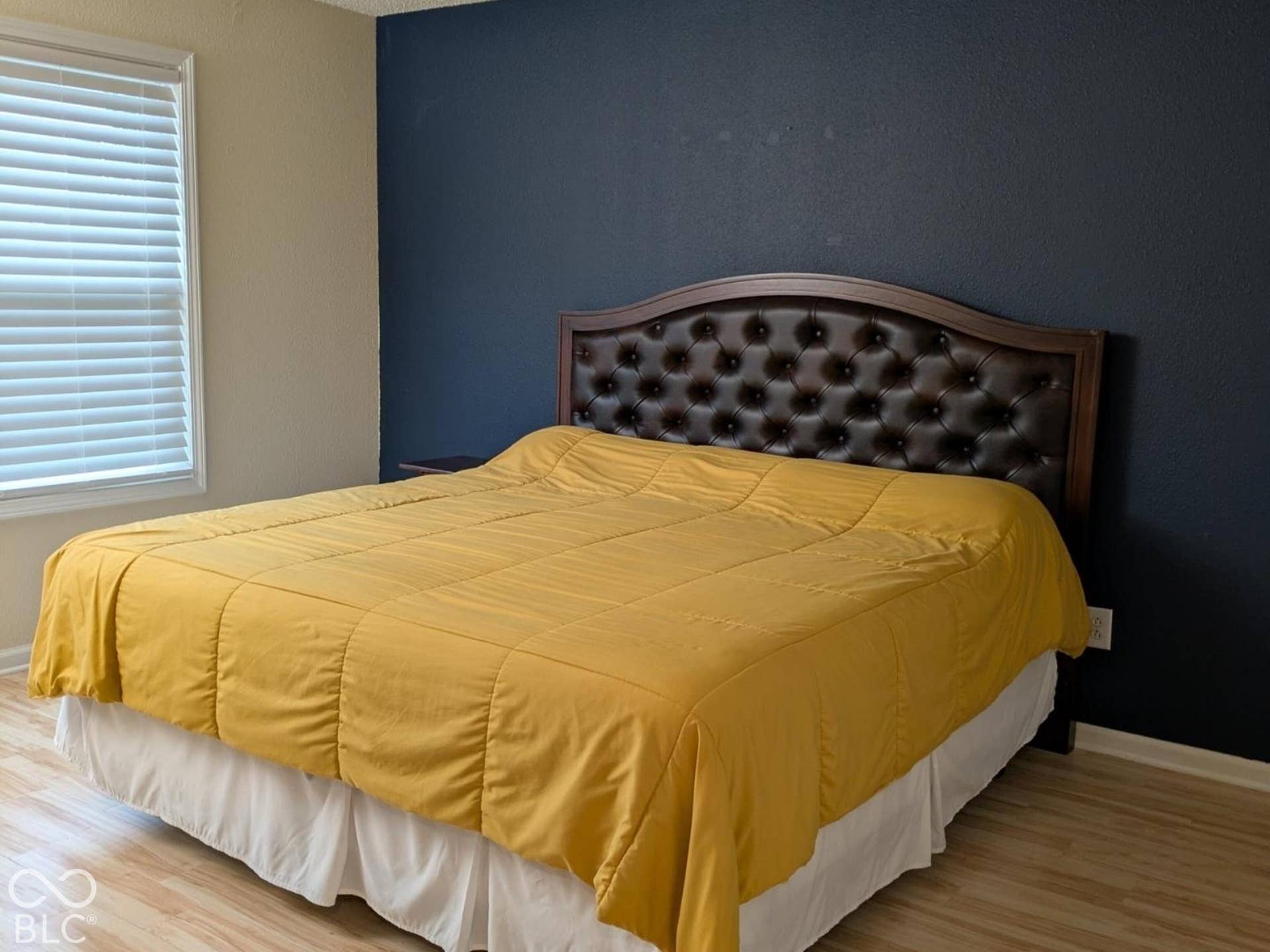 Light wood-finish flooring with a contrasting accent wall