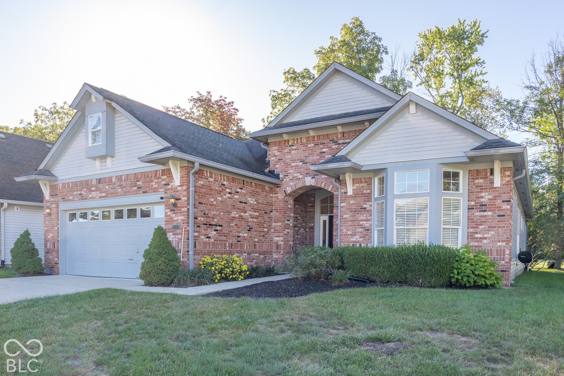 Brick and siding exterior with a prominent bay window