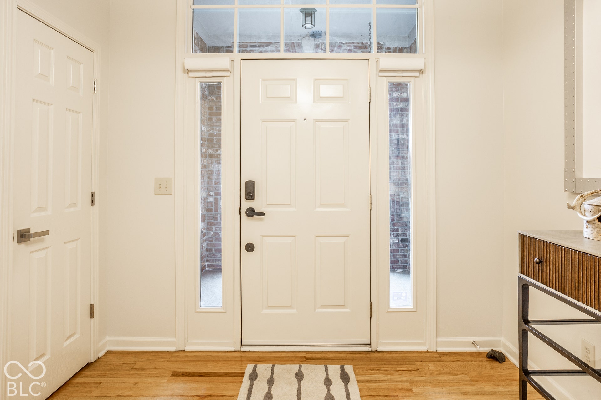 Bright entry greets with hardwoods