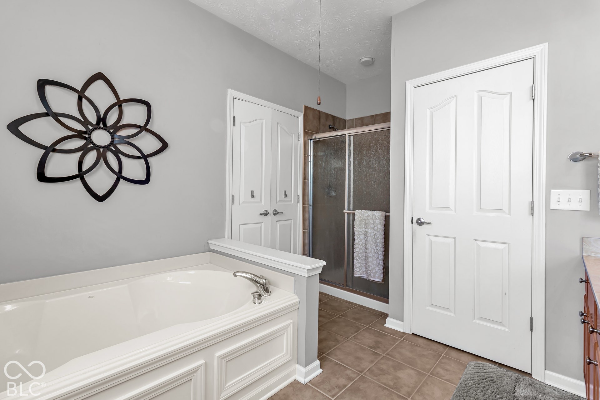 The suite also includes a tile shower and separate soaking tub.