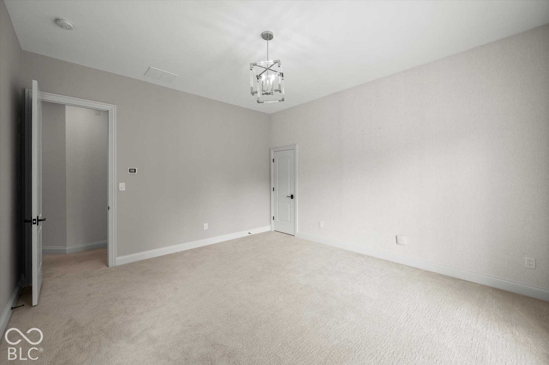 Neutral wall colors, carpeted flooring, and a modern ceiling fixture