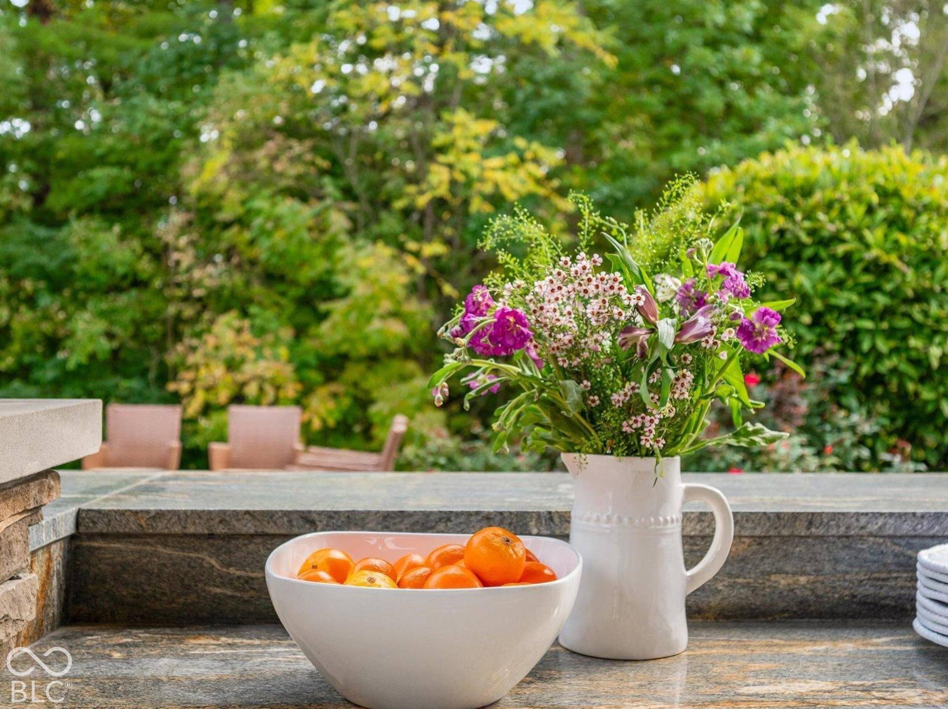 Outdoor countertop with a built-in appliance, featuring a polished stone surface and a stone facade