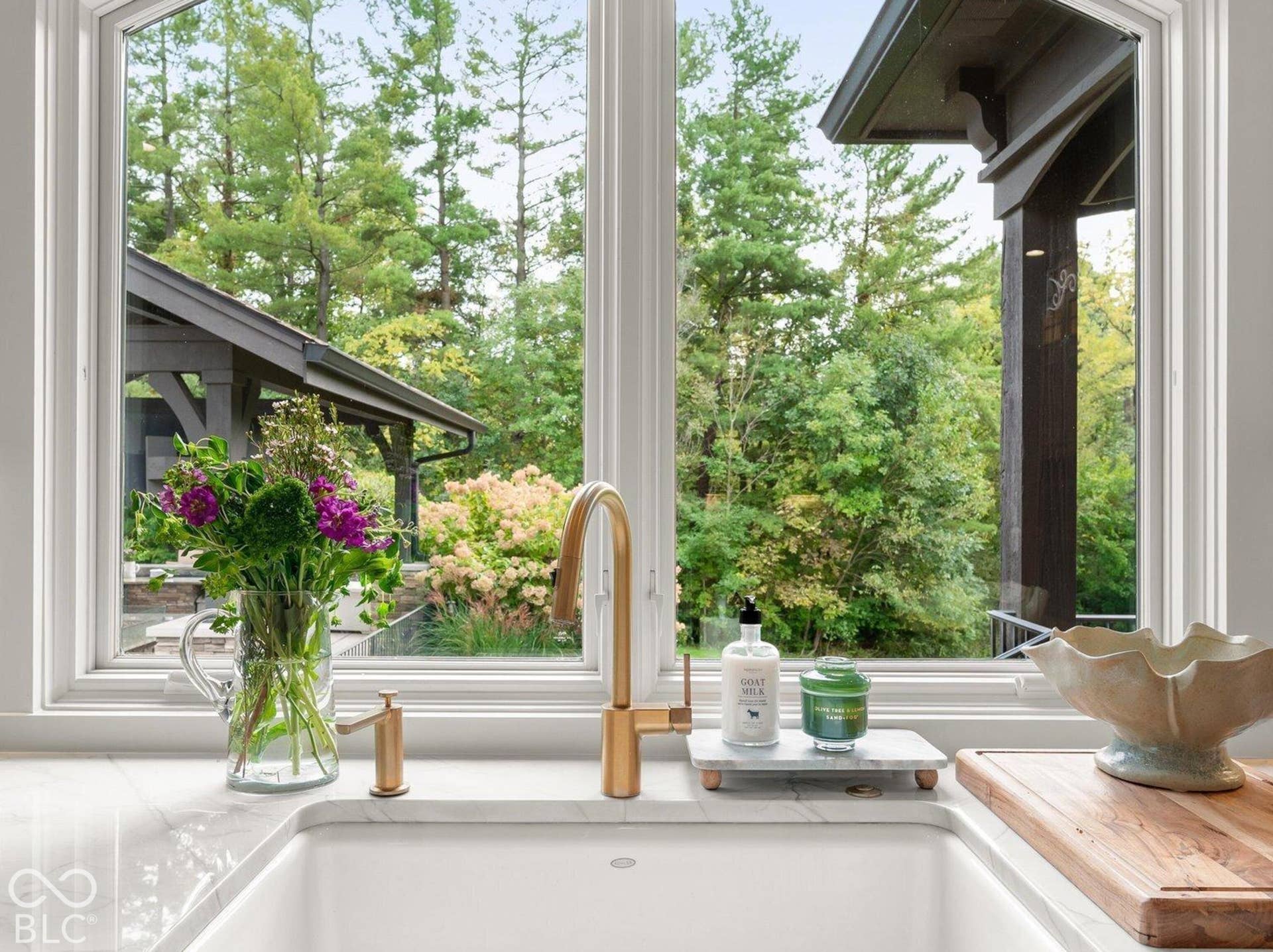 Arched window with extensive natural light, undermount sink, and integrated countertop
