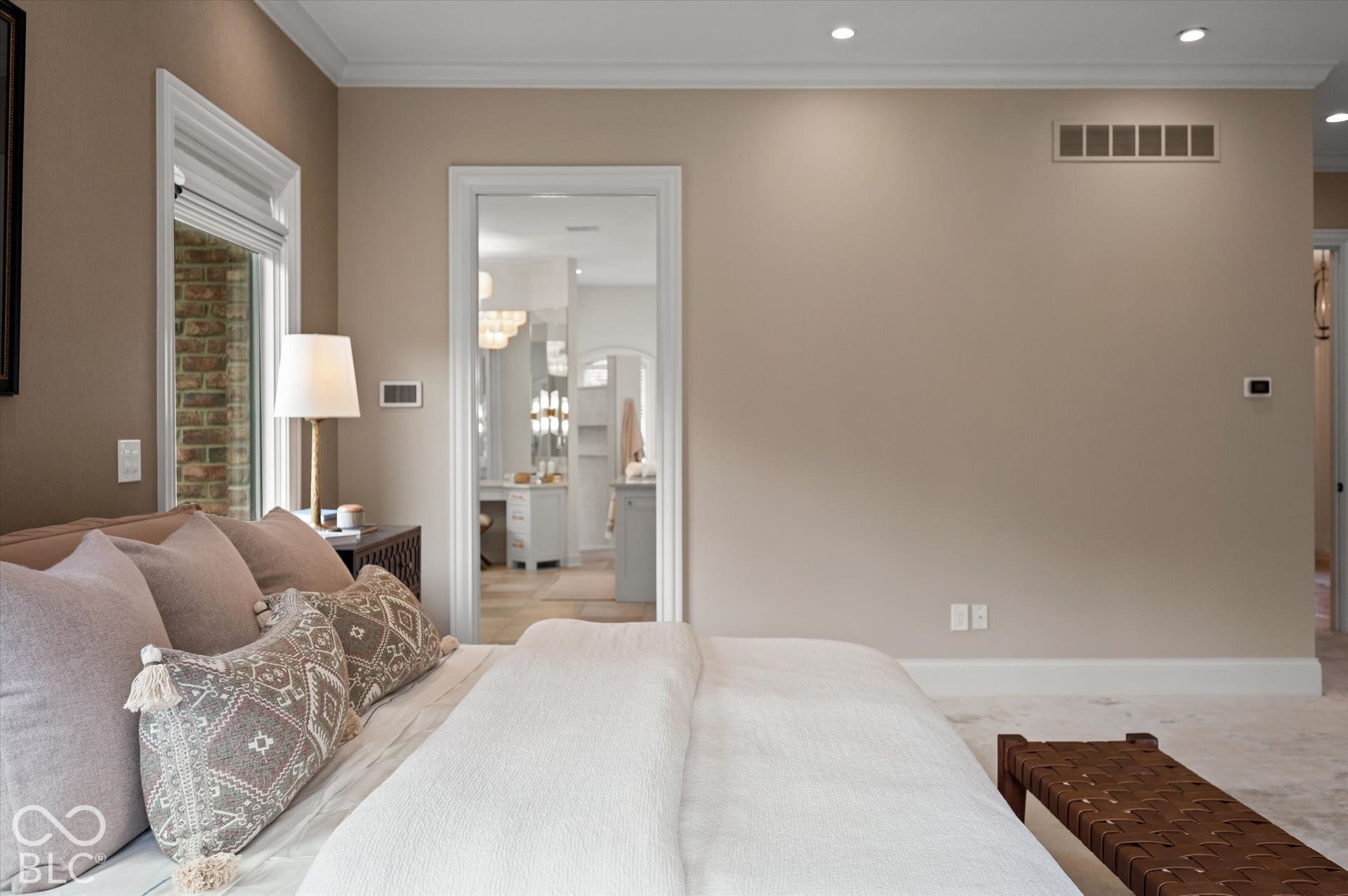 Recessed lighting, crown molding, and a window with brick exterior