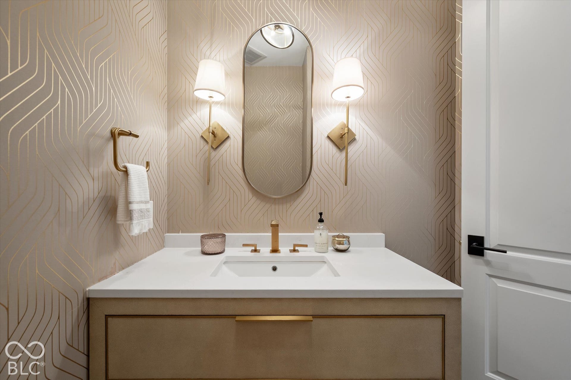 Vanity with an integrated sink, gold-finish faucet, and white countertop