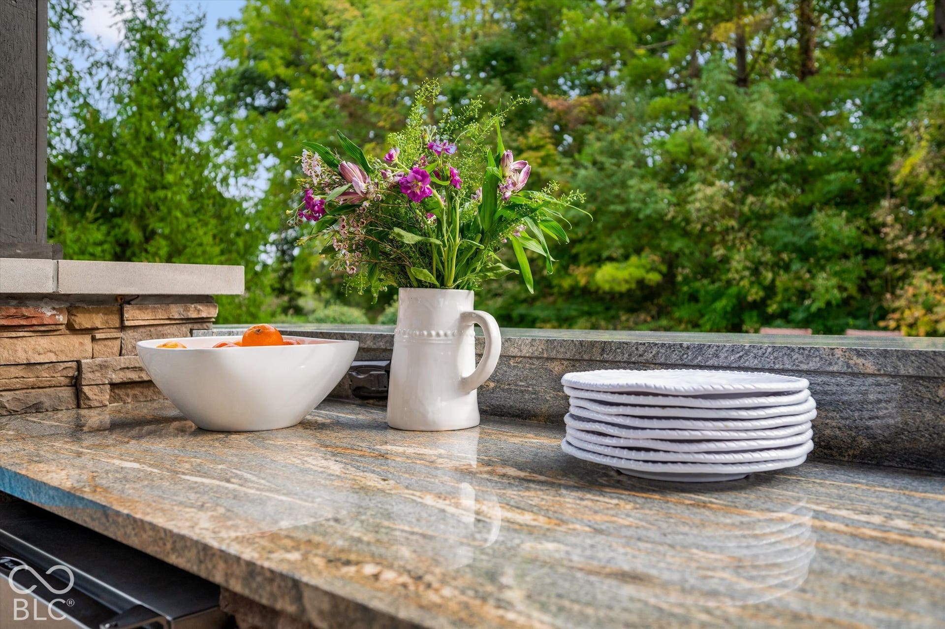 Outdoor countertop featuring a stone finish and stacked stone base