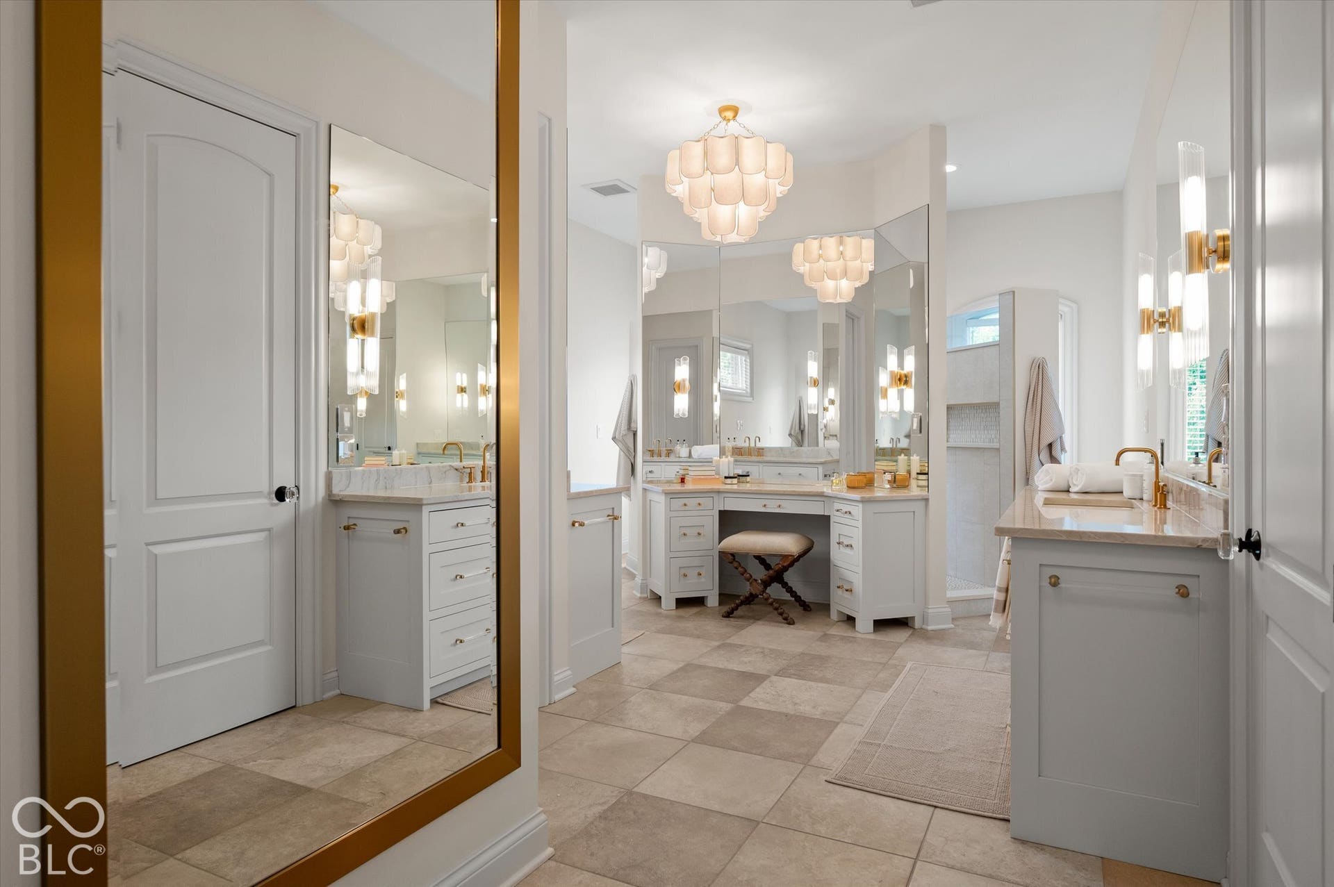 Dual vanity areas featuring stone countertops and integrated sinks