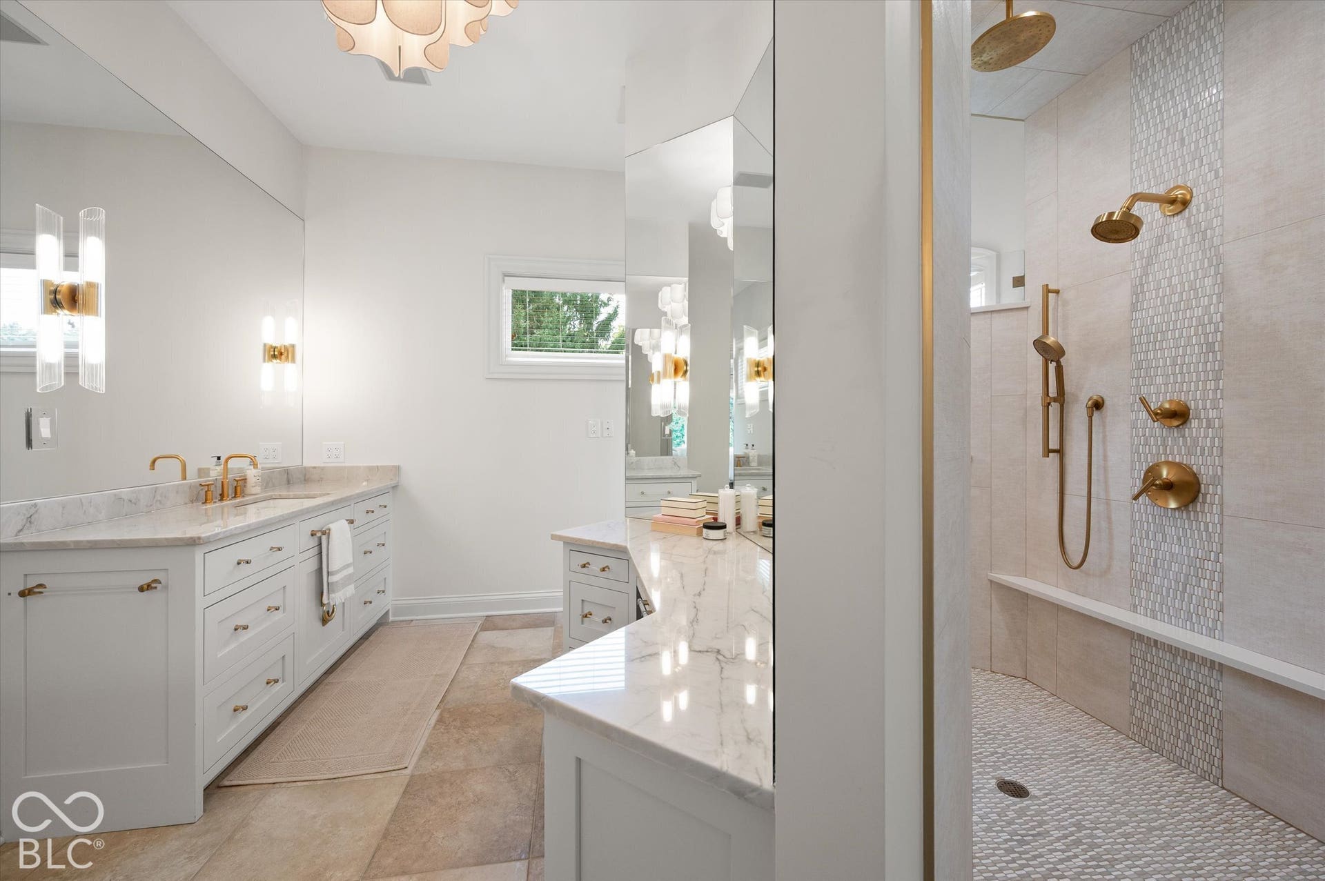 Dual vanity with white cabinetry and stone countertops