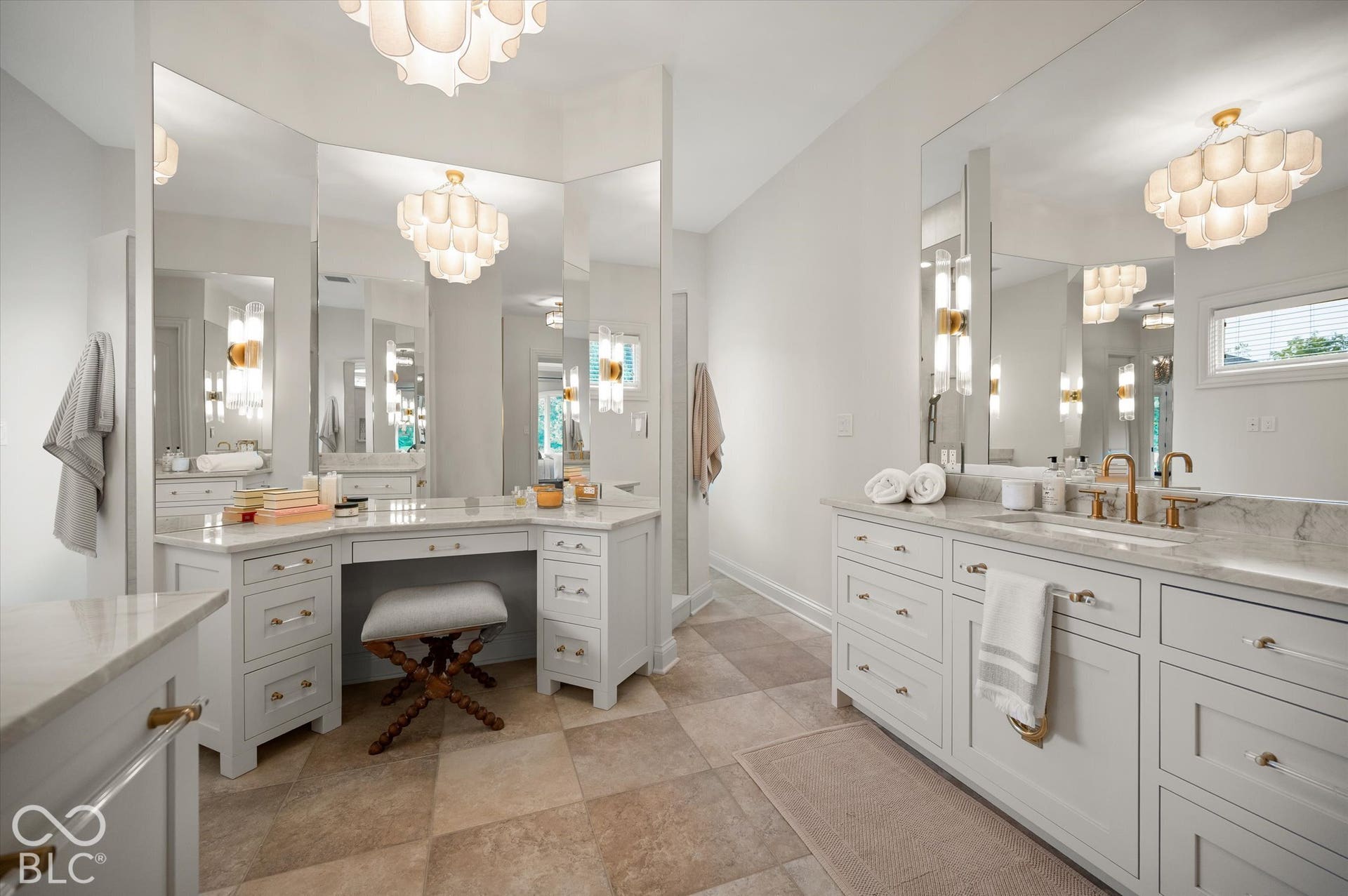 Dual vanity with undermount sinks, bronze finish fixtures, and a light-toned countertop